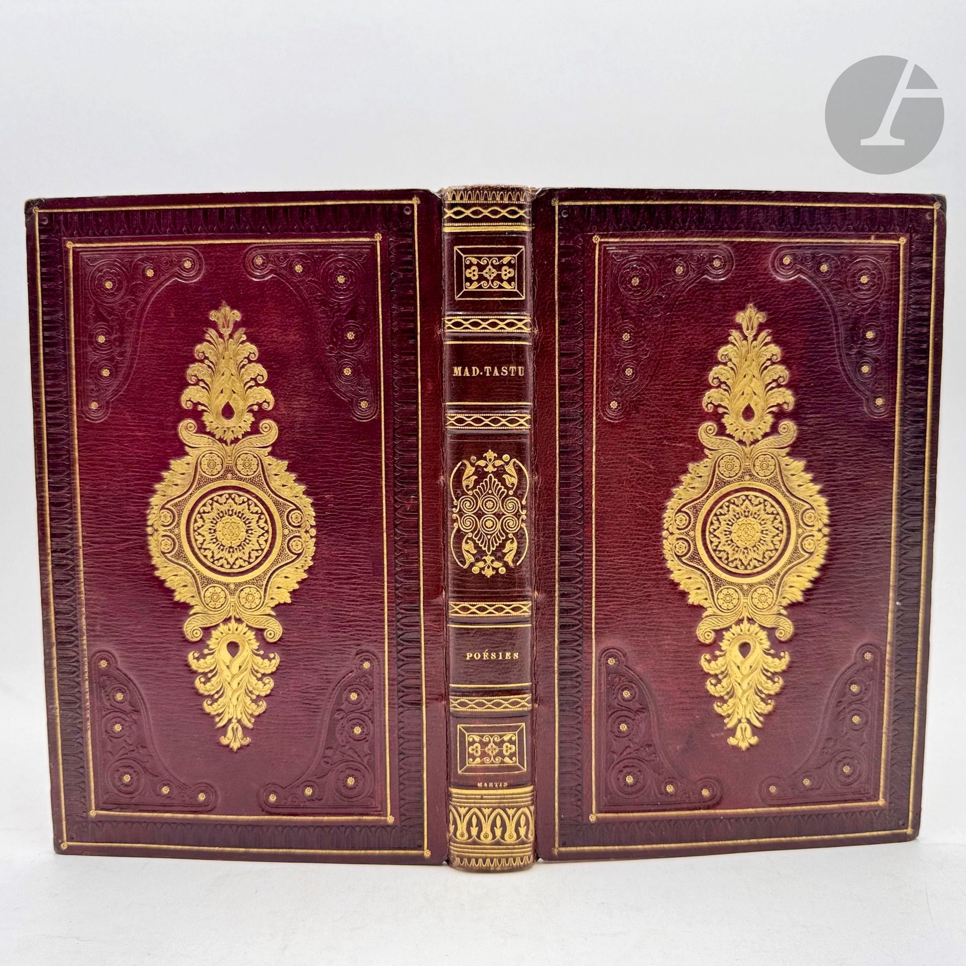 TASTU (Amable).
Poésies.
Paris : Ambroise Dupont et Cie, J. Tastu, 1827. — In-8, maroquin aubergine à long grain, plats ornés d'un cadre formé d'une roulette aux palmettes entre deux filets dorés et au centre d'une belle plaque restauration dorée et d'un fer rocaille à froid et doré aux angles, dos à faux nerfs orné de motifs dorés, roulette dorée intérieure, tranches dorées (Martin).
Troisième édition de ce recueil de poèmes d'Amable Tastu, illustré d'un frontispice gravé sur acier d'après un dessin d'Achille Devéria.

Exemplaire dans une superbe reliure de l'époque signée de Martin, comprenant le frontispice tiré sur chine collé.

Discrètes restaurations aux coins. Infimes rousseurs.