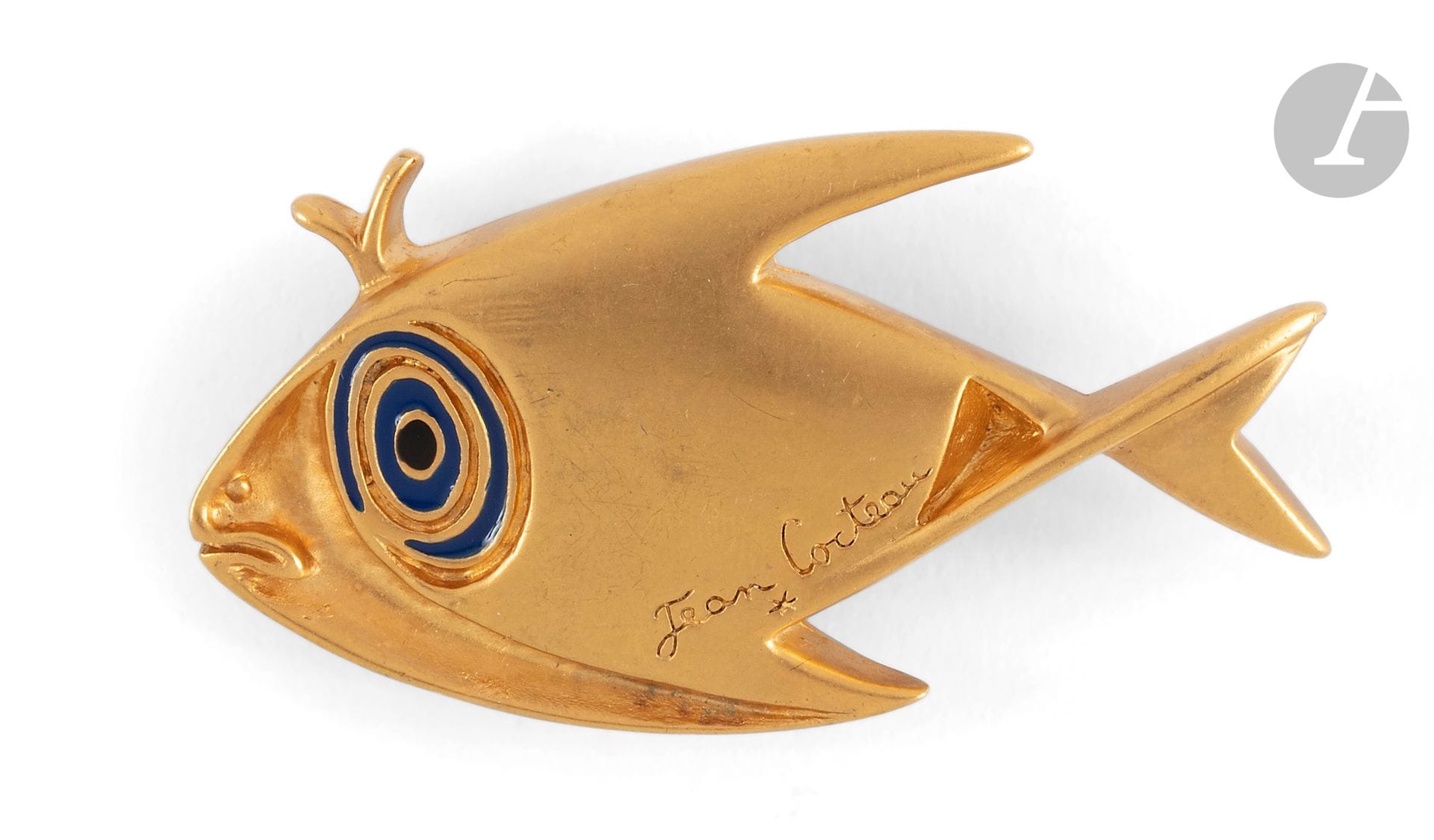 D'après Jean COCTEAU (1889-1963)
Poisson, 1997
Broche en bronze doré et émaillé.
Signée.
Pastille (c)1997 Comité Jean Cocteau - A. Madeline - Flammarion au dos.
(Petites usures).
Dimensions : 3,5 x 6 cm