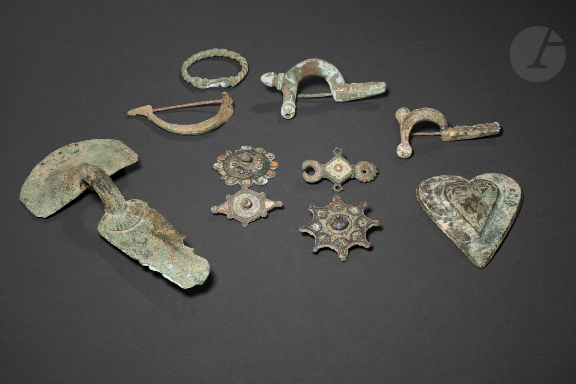 Four fibulas, two of them cruciform, and a twisted ring
Bronze, enamel. As is.
Merovingian and earlier periods
Max. length 15 cm 
Five enameled sconces are included. 

Four Merovingian or earlier Bronze Enamel Fibulas and a Ring