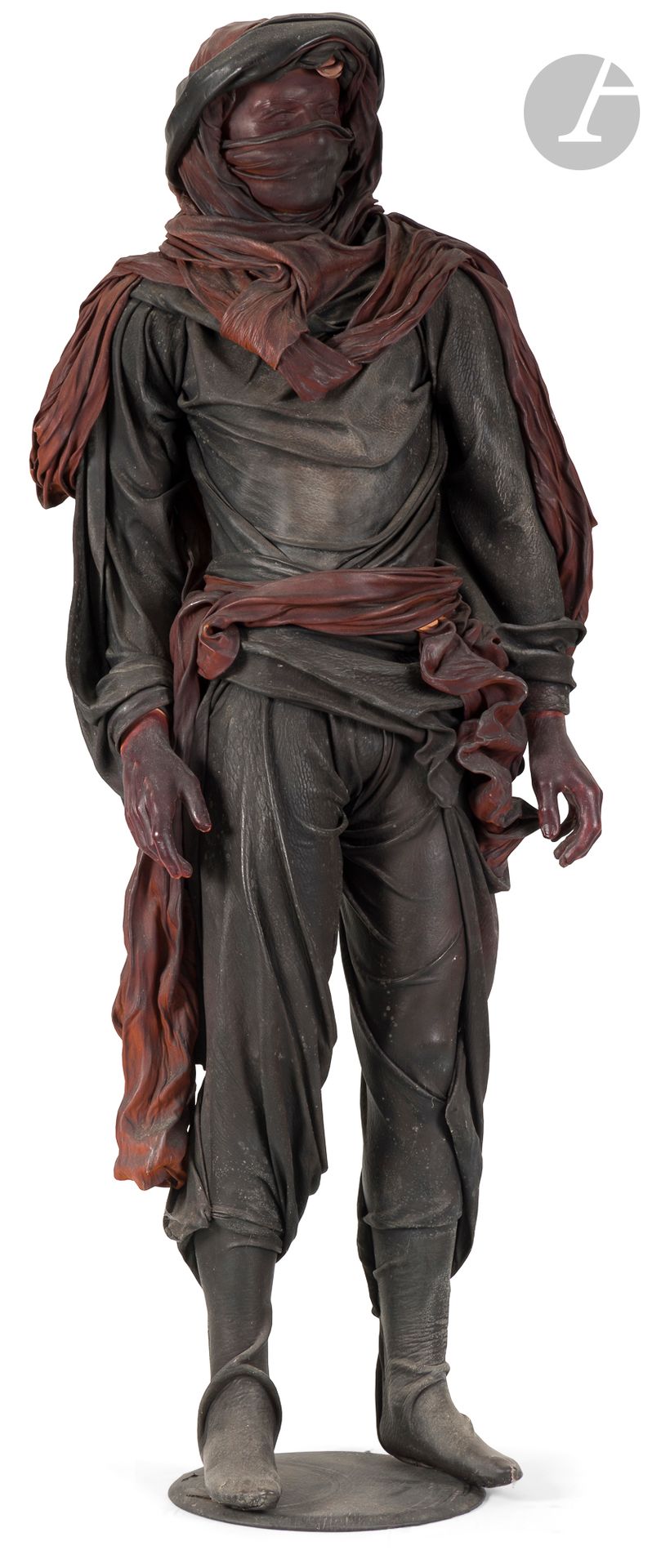 Mannequin of a man, probably Tuareg, in leather.
Dressed in a cheich tied into a turban, and a brown leather belt, the rest of his clothes in black leather. Metal base trimmed with black leather.
20th century.
H. 179 cm 
Slight traces of humidity on the leather.