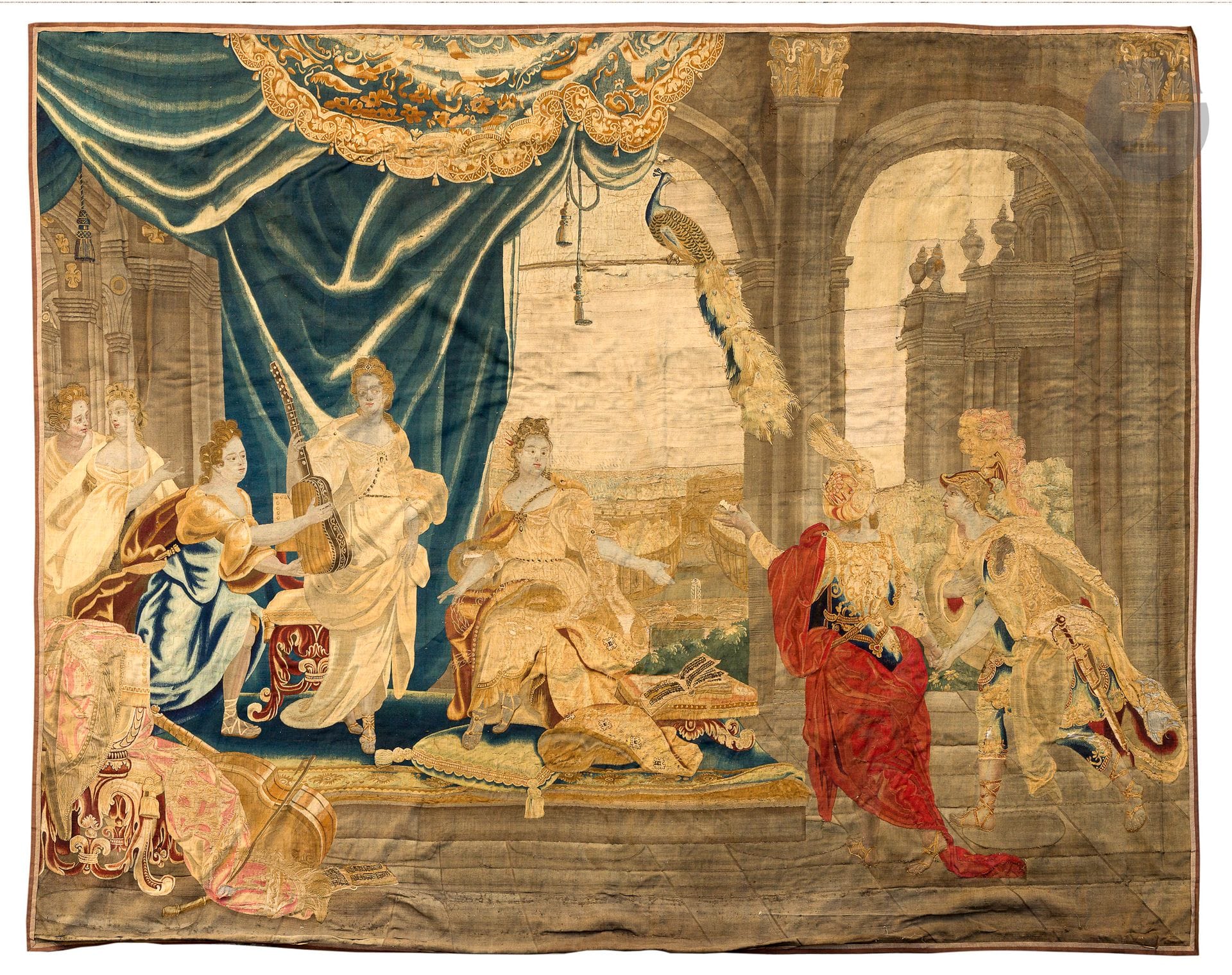 Wool and silk tapestry on the theme of music, decorated with a seated central figure with a music book open in front of him, surrounded by several figures playing music and holding instruments. On the right, a gentleman and a servant. A peacock is hidden at the top of the composition.  
Brussels, 18th century. 
340 x 420 cm
Numerous restorations to the sky and silk parts. Wear, holes. Missing border all around. 
Lined. Re-inlay and fired silk.