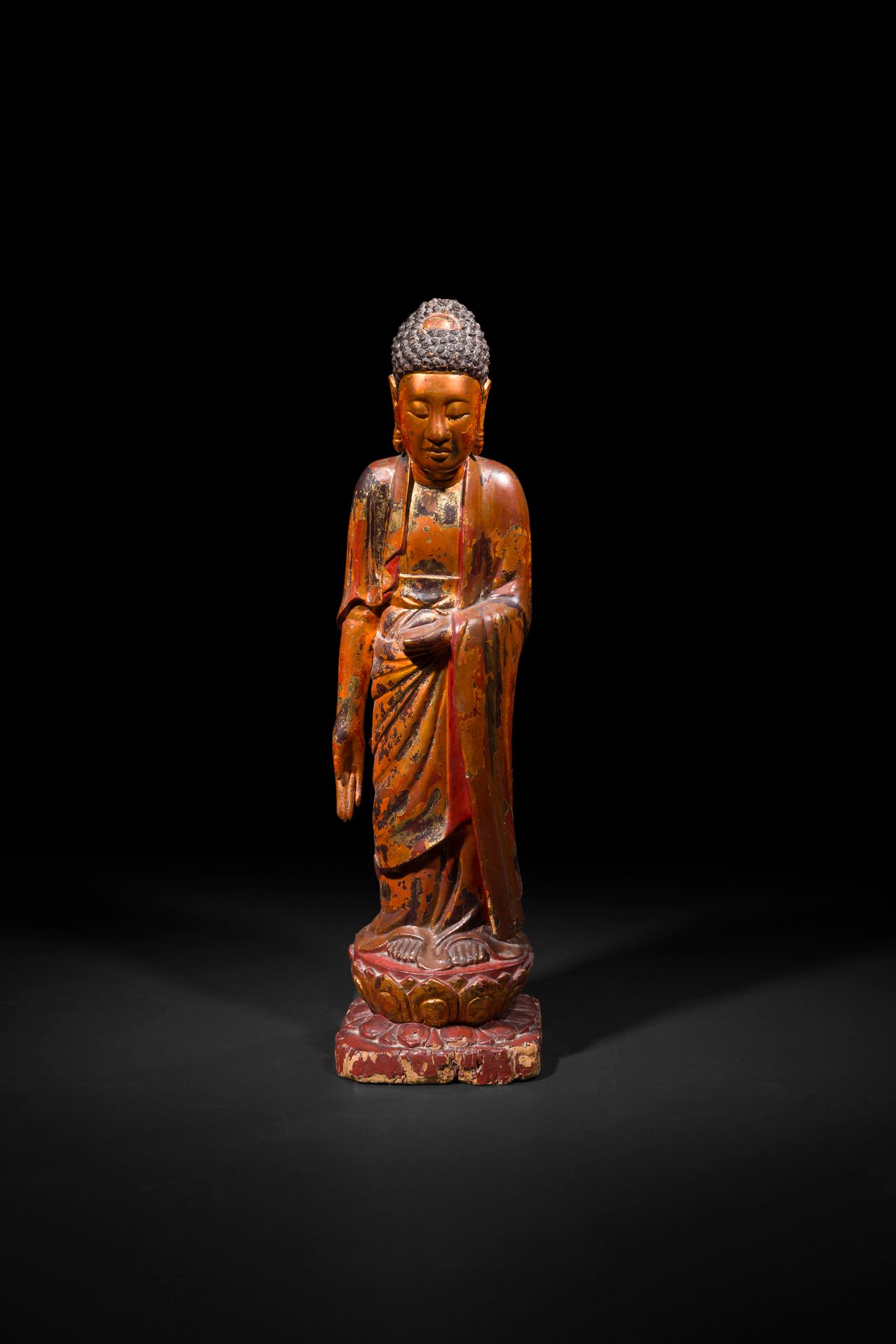 Large gold-lacquered wooden Buddha, Vietnam, 19th - 20th century
He stands with his right hand in varada mudra, the gesture of giving, and his left arm bent in a meditative position. It stands on a double lotiform pedestal formed by a square base and a circular pedestal. It was covered with red lacquer and then gilded with gold leaf.
Height: 90 cm
Chips, accidents, gilding wear.