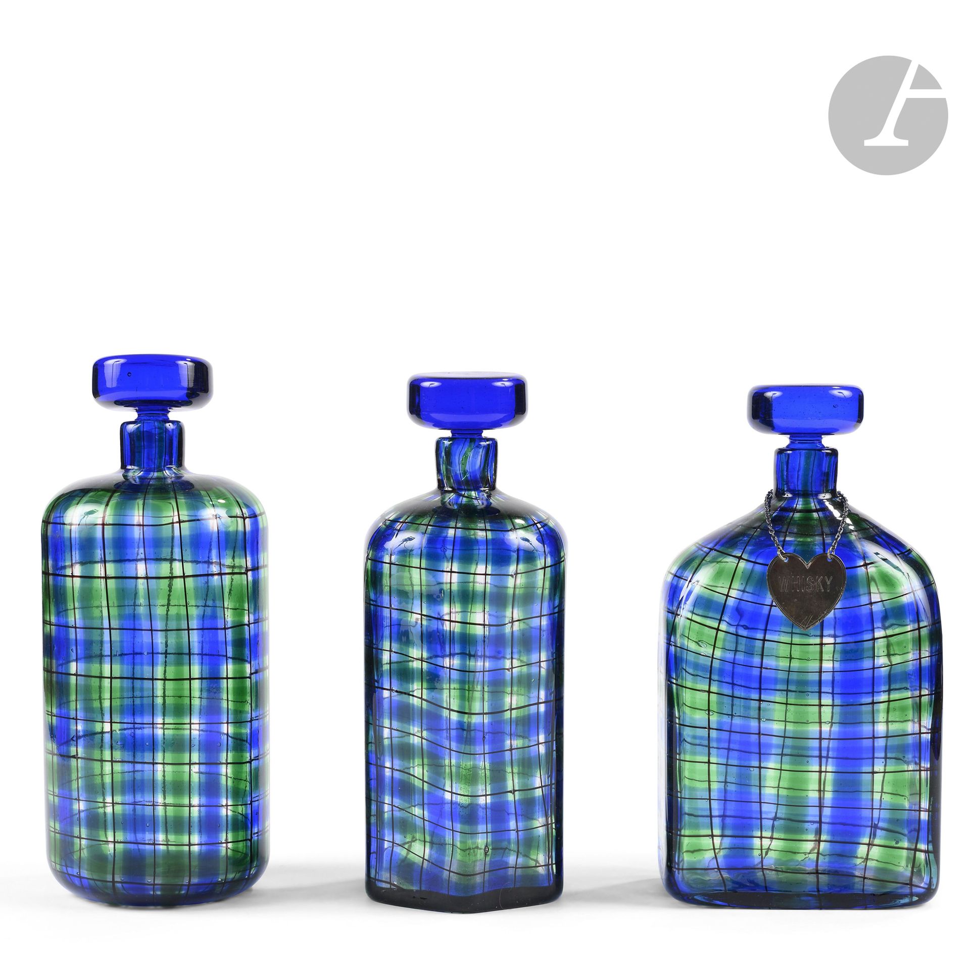 BAROVIER &amp; TOSO ART GLASSWARE FOR CHRISTIAN DIOR
Tartan
Suite of 3 bottles; one flat, one faceted, one cylindrical; the stoppers are circular. Glass proof with polychrome decoration. The stem of the stopper on the round bottle is broken and glued to the inside of the mouth of the base, and the mouth of the faceted bottle is cracked. Each marked Christian DIOR, at the point below the base. H.24cm &amp; H.25,5cm &amp; H.25,5cm