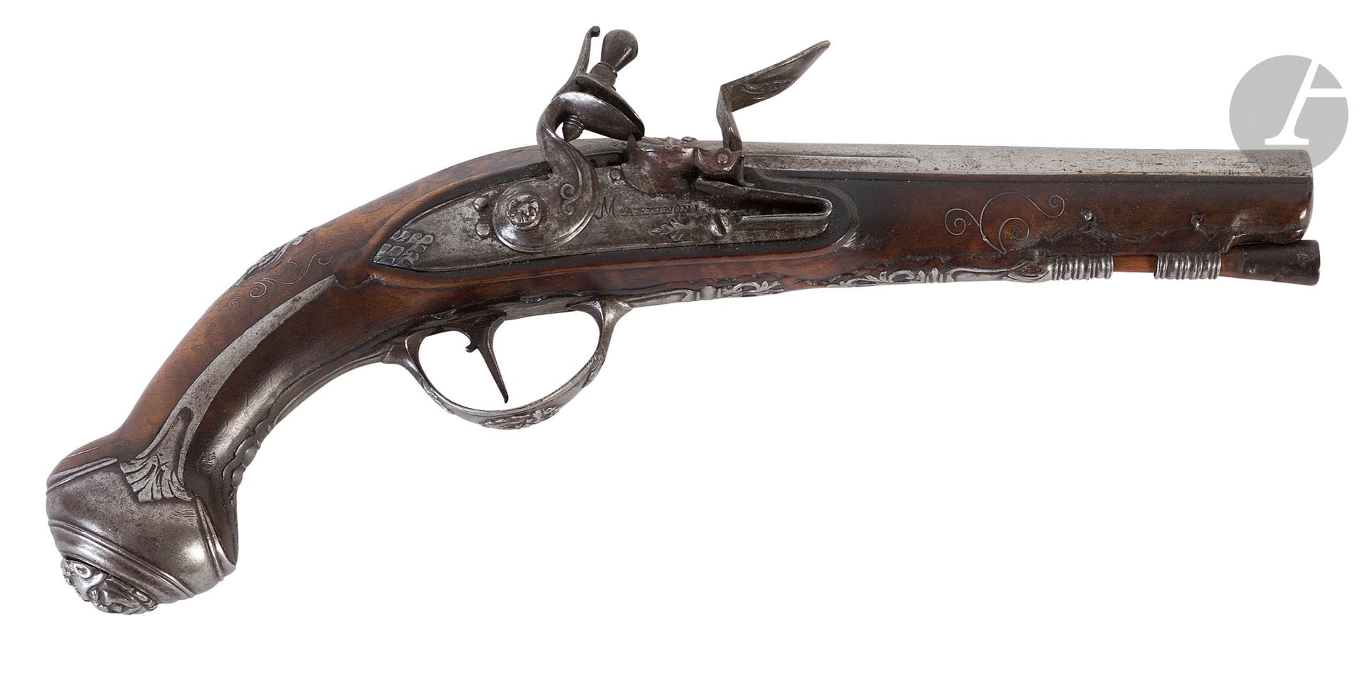Italian flintlock travel pistol.
Round barrel with flat top signed "L. LAZARINO", with thunderbolt decorated with a grimacing mask.
Lock signed "MARTINONI" and gooseneck hammer with round body chased with foliage.
Round iron bassoon, cut iron fittings engraved and chased with foliage and decorated with grimacing masks, long-eared pommel, walnut frame, long-stemmed stock decorated with silver wire inlays, en suite thumbpiece, mask, wooden ramrod.
Circa 1760-1780. 
A.B.E. (shortened weapon).