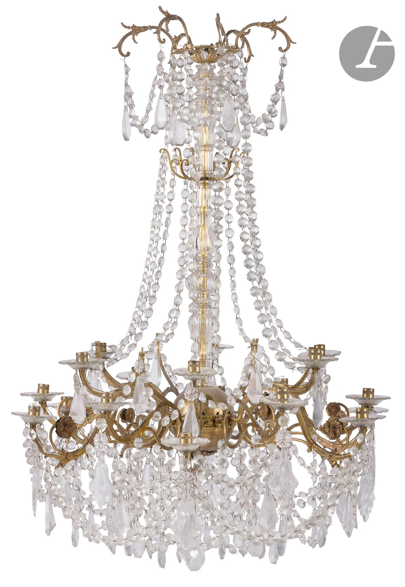 Eighteen-light gilt brass and cut-glass chandelier with cabochon garlands and pendants; (electrically mounted; six lights missing from the top row).
Louis XV style, 19th century.
H : 112 cm, W : 90 cm