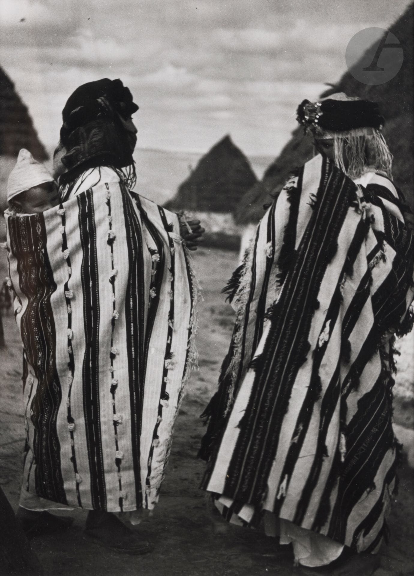 Jean Besancenot (1902-1992) 
Morocco, 1934-1939. 
Middle Atlas. Two women from the Zemmour tribe wrapped in the very large wool tanuzart that each Berber woman weaves on her family loom. 
Silver print (c. 1980), matted, signed in pencil on the mount lower right. Handwritten caption and negative number in pencil inside lower mount. 
23.8 x 17.7 cm