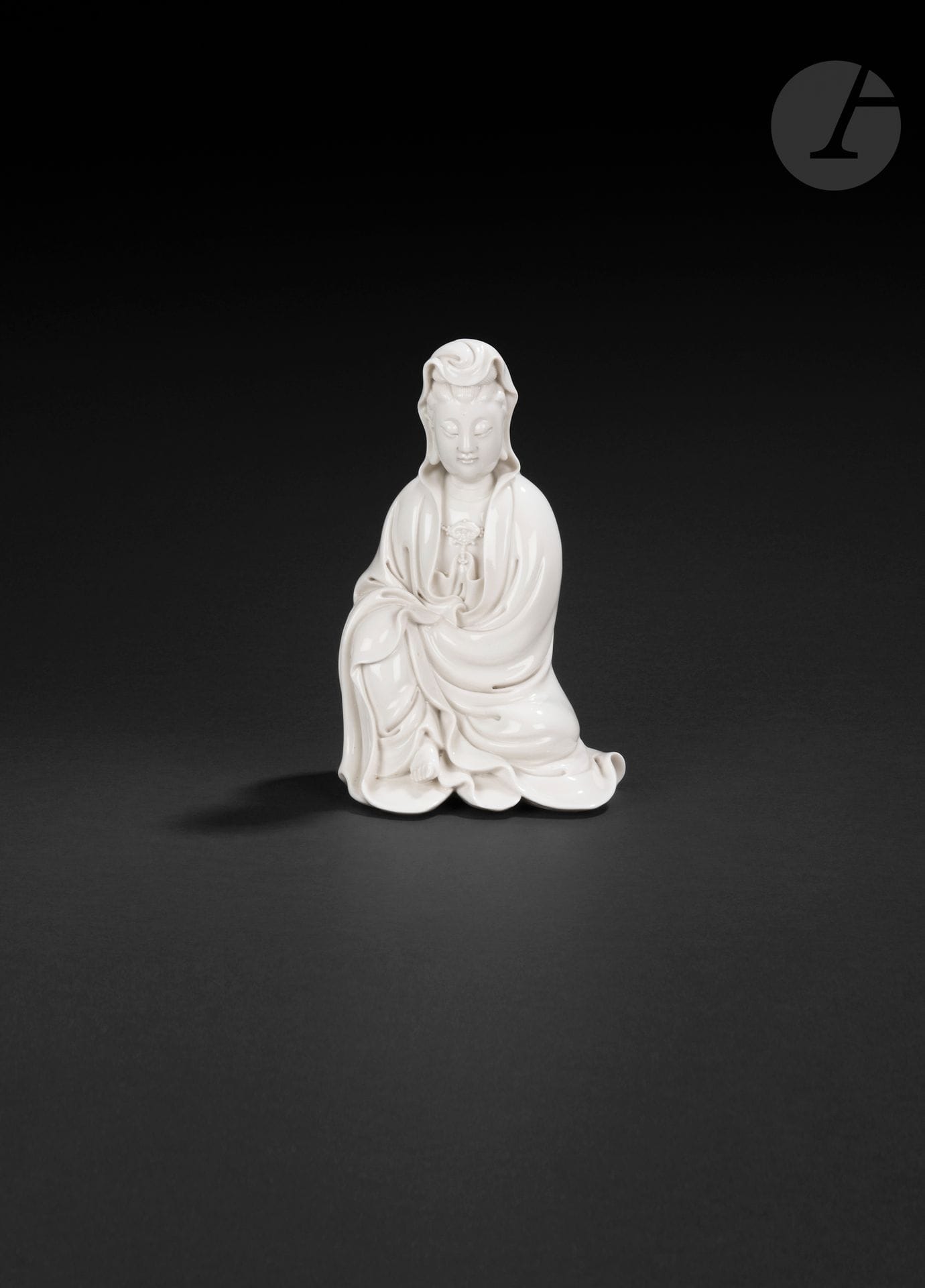 Chinese white porcelain Guanyin, Dehua, China, 17th century
Seated, wearing a pleated robe open to the chest, and adorned with a pearl necklace at the center of which is a lingzhi mushroom head. Her face is serene, her eyes downcast and her hair gathered into a bun covered by the robe. His forehead is adorned with a central urna. On the back are two seals: a molded double-gourd seal with the Zhuanshu inscription "He Chao Chun"-何朝春 and a molded square seal with the Zhuanshu inscription "Xuande"-宣德.
Height : 20 cm

A Dehua potter, He Chao Chun is the brother of He Chao Zong.