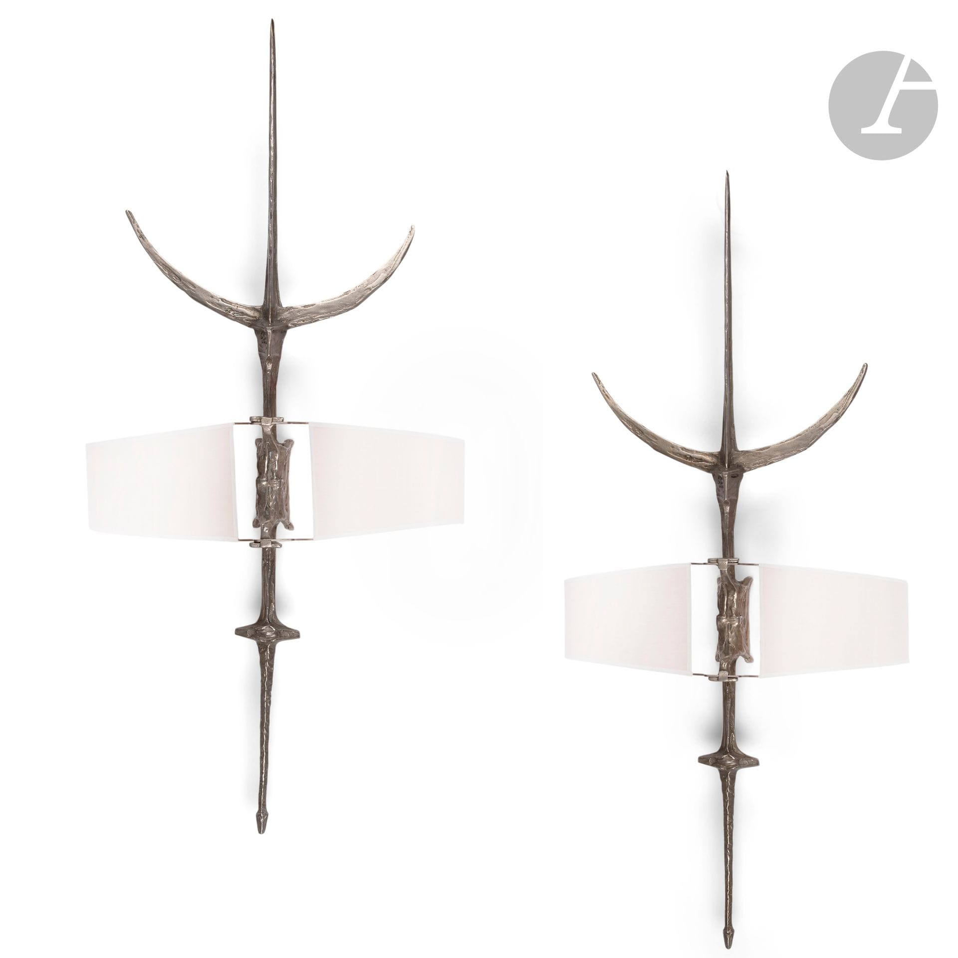 FÉLIX AGOSTINI (1912-1974)
Halberds, the model created in [1968-1969].
Pair of spectacular sconces. Silver-plated bronze proofs. Each complete with its central double-screen shade. Early editions. The fabric of each shade replaced. Each sconce signed AGOSTINI on reverse. H.112cm

Bibliography:
Félix Agostini by Charles Paris - Amour, Volume 2 - Éditions Maison Charles, Paris, 2016. Identical models reproduced on pages 146, 148 and 149; model plan reproduced on page 206.