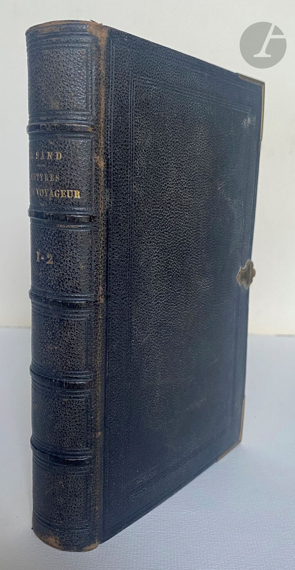 SAND (George).
Lettres d'un voyageur.
Paris : Félix Bonnaire, 1837. — 2 tomes en un volume in-8, chagrin noir, filets à froid en encadrement sur les plats, pièce de métal aux angles, fermoir en métal, dos à nerfs orné de filets à froid, tranches dorées (reliure de l'époque).

Édition originale formant les tomes XV et XVI de l'édition des Œuvres de George Sand publiée par Bonnaire.

Rare exemplaire en plein chagrin de l'époque avec fermoir et coins en métal.

Frottements aux coiffes et aux charnières, traces blanches sur les plats. Gardes tachées, rousseurs éparses.