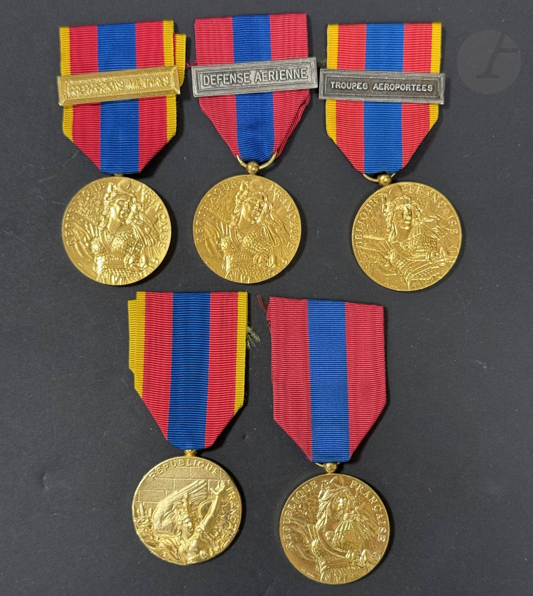 FRANCE 
MÉDAILLE DE LA DÉFENSE NATIONALE 
Réunion de onze médailles : sept de fabrication du modèle officiel, quatre de fabrication privée, trois modèles « Or », trois modèles « argent ». 
Agrafes « Gendarmerie nationale », « État major », « Justice militaire », « Préparations militaires », « Troupes aéroportées », « Défense aérienne » et « Génie de l’air ».