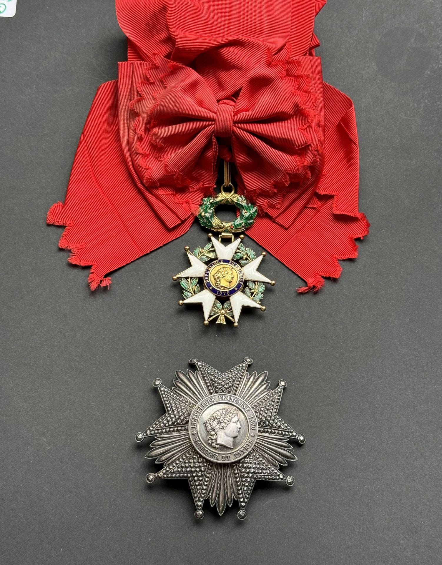 FRANCE 
ORDRE DE LA LÉGION D’HONNEUR 
Ensemble de « grand-croix » d’époque IIIe République comprenant : 
- Une étoile de commandeur, en or et émail (accidents et manques). Poinçon d’orfèvre (illisible présumé d’Aucoc). 
Monté sur une écharpe de grand-croix. 
B. 
- Une plaque de grand-croix. 
En argent. Centre en plusieurs parties. Revers à attache basculante. 
90 mm
T.T.B. 
Provenance marseillaise.