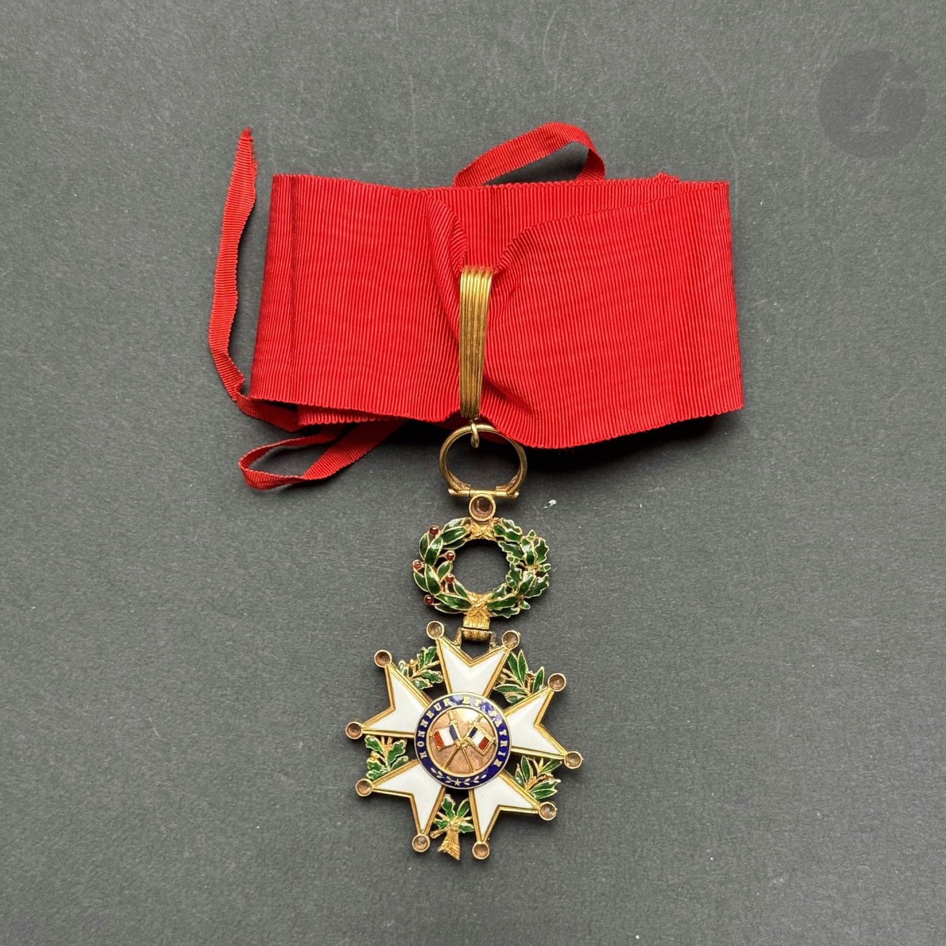 FRANCE 
ORDRE DE LA LÉGION D’HONNEUR 
Étoile d’officier d’époque IIIe République, montée en commandeur, modèle de luxe, ornée de diamants et feuillages en relief. 
En or ciselé, à filets, anneau ciselé, pointes ornées de petits diamants taillés en rose. Centres en deux parties. Cravate avec attache. 
75 x 41 mm - Poids brut : 25 g
T.T.B.