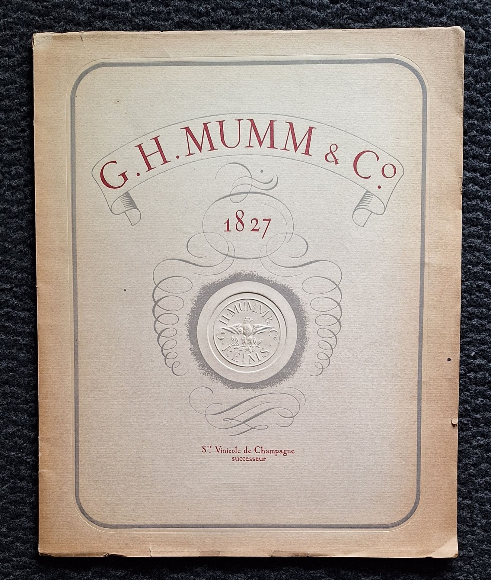 ALBIN GUILLOT, LAURE (1879-1962)
G.H.Mumm &amp; Co 1827. 
Société Vinicole de Champagne, successor.
Imprimerie Desfossés, 1948.
In-4 (30 x 24 cm). First edition of this promotional brochure, whose sepia photographs, reproduced in gravure, are all by Laure Albin Guillot (48 photographs, including one on a loose leaf). The book also features a color photographic reproduction by André Steiner. 50 pp. A map of the Champagne region. Foreword with a sonnet by Ronsard. Illustrated and titled soft cover, with dry-engraving of the "Mumm, Reims" medallion.