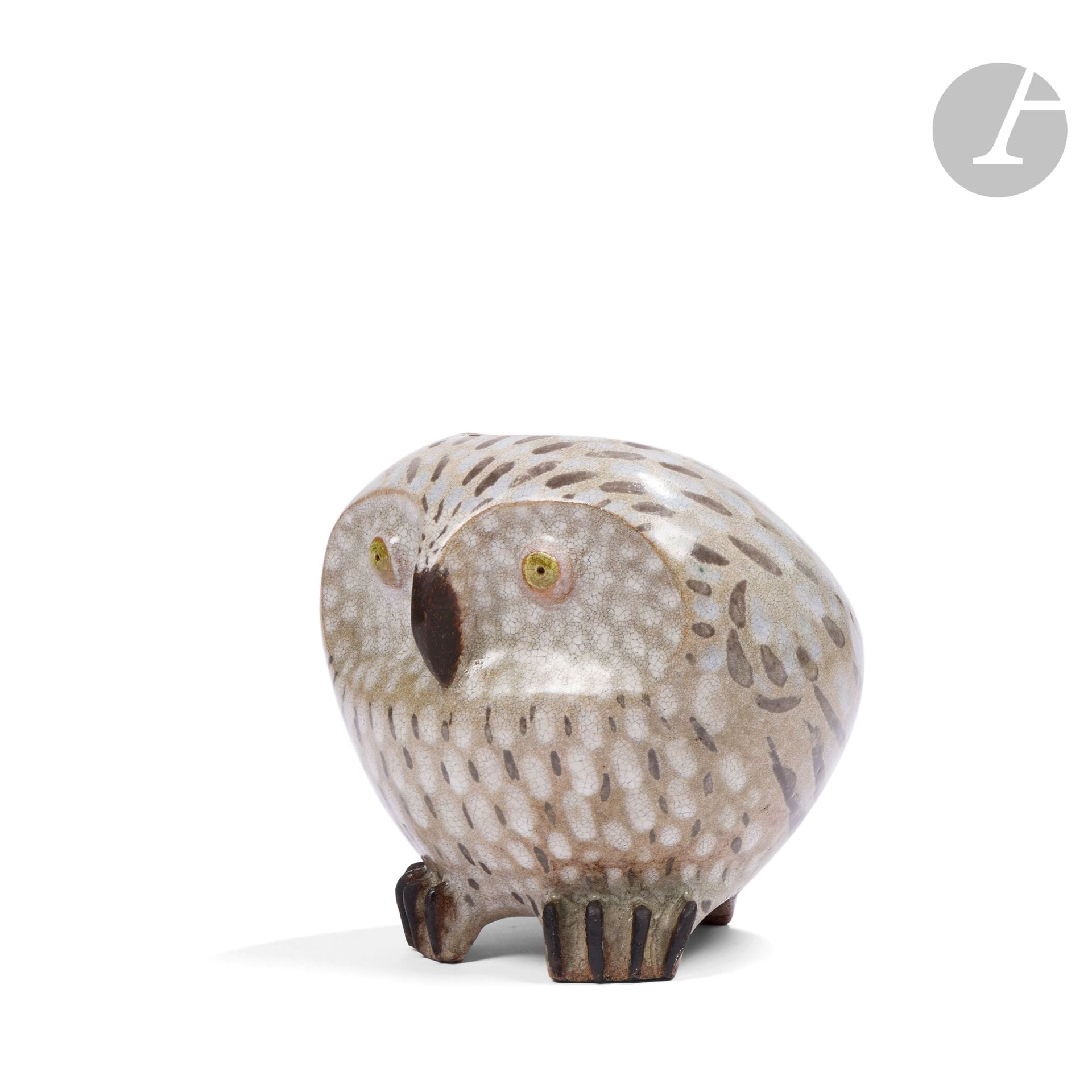FRANÇOIS RATY (1928-1982)
Owl, 1954
Zoomorphic vase.
Glazed ceramic proof; the polychrome plumage on an ivory and brown background with fine craquelure.
Signed, located and dated RATY 1954 Vallauris, in incisions under the glaze, bears an incomplete label, possibly from an exhibition, with handwritten notes in ink.
Height: 19 cm - Length: 20 cm - Depth: 17 cm

Please note:
A work similar to our Chouette appears on a poster for an exhibition organized by Galerie 65 in Cannes, from April 5 to April 24, 1958.