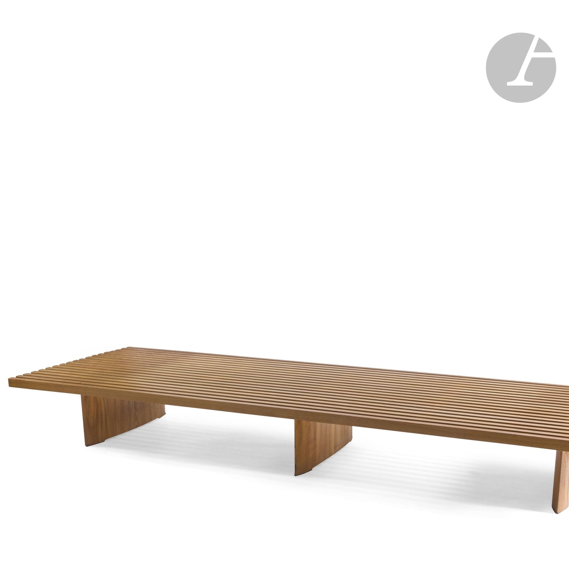 CHARLOTTE PERRIAND (1903-1999) - SUCCESSION X., MANTES-LA-VILLE
Tokyo, modèle conçu vers [1953-1954] pour la maison de Jacques Martin à Tokyo, équipant le Musée National d’Art Moderne à Paris (installation en 1963-1965), notre œuvre acquise à la Galerie Steph Simon vers 1960
Grande banquette (combinable) de repos. 
Les trois pieds de section elliptique, les dix-neuf lattes longitudinales 19 et celles de liaison, formant la structure d’assise, en frêne.
État d’usage, petits accidents et manques épars.
Hauteur : 26,5 cm – Longueur : 224,5 cm – Profondeur : 73,5 cm

Provenance :
Succession X., Mantes-la-Ville. Œuvre acquise auprès de la Galerie Steph Simon vers 1960. Cette banquette faisait partie d’un aménagement complet conçu par le décorateurColas Guérin pour M. et Mme X., comprenant un ensemble mobilier de Charlotte Perriand (notre banquette, deux tabourets Berger, table à gorges et suite de chaises) complété d’une applique de Serge Mouille et d’un meuble d’André Chetaille et présentés sous les numéros précédents et suivants de cette vacation.

Bibliographie :
- Aujourd’hui Art et Architecture – N° 7 de mars 1956. Modèle identique et/ou variantes de dimensions reproduits pages 76, 80 et 81.
- Jacques Barsac - Charlotte Perriand – L’œuvre complète – Volume 2. 1940-1955 – Édition Archives Charlotte Perriand/Norma, Paris, 2013. Le bleu du modèle Tokyo reproduit page 442 et un modèle identique reproduit pages 442 et 444.
- Jacques Barsac - Charlotte Perriand – L’œuvre complète – Volume 3. 1956-1968 – Édition Archives Charlotte Perriand/Norma, Paris, 2017. Modèles identiques figurant sur des photographies du Musée National d’Art Moderne reproduites pages 422 et 423. 
- Charlotte Perriand, Un art d’habiter – Jacques Barsac, Éditions Norma, Paris, 2005. Le bleu du modèle Tokyo reproduit page 393 et un modèle identique et/ou des variantes de dimensions reproduits pages 403 et 405.
- Collectif - Charlotte Perriand, an Art of living-ÉditionsMary McLeod New York 2003 Publications Harry N. Abrams Inc., New York, 2003. Modèle identique ou variante de dimensions reproduit page 145.