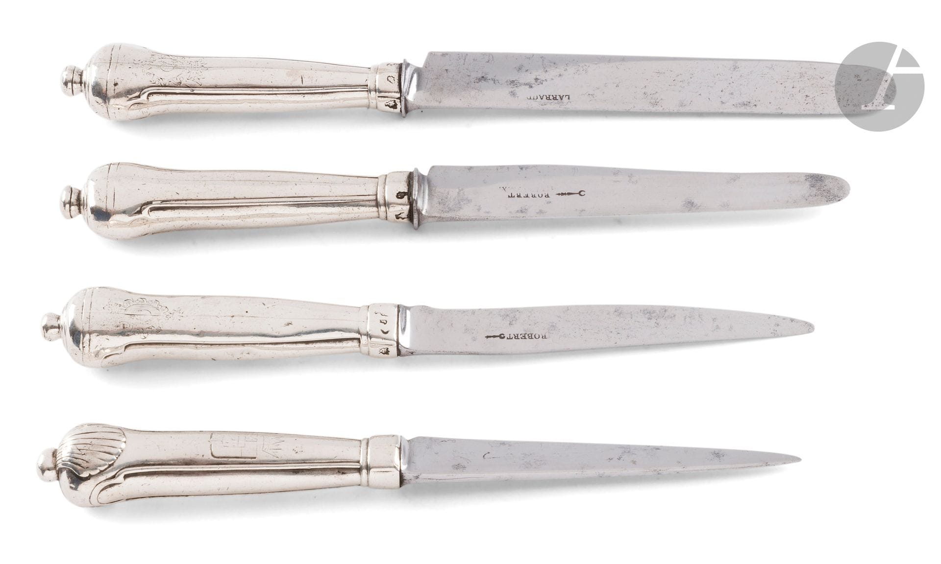 FRANCE FIRST HALF OF THE 18th CENTURY
Four silver table knives, three of them of the button pattern, engraved with the same coat of arms (very faded), underlined by the cross of Saint-Louis and topped by a marquis crown. Blades changed for two.
PARIS 1737 - 1738 for one and two for 1738 - 1739
The fourth model with a shell knob, engraved with a 19th-century coat of arms.
Gross weight: 464 g