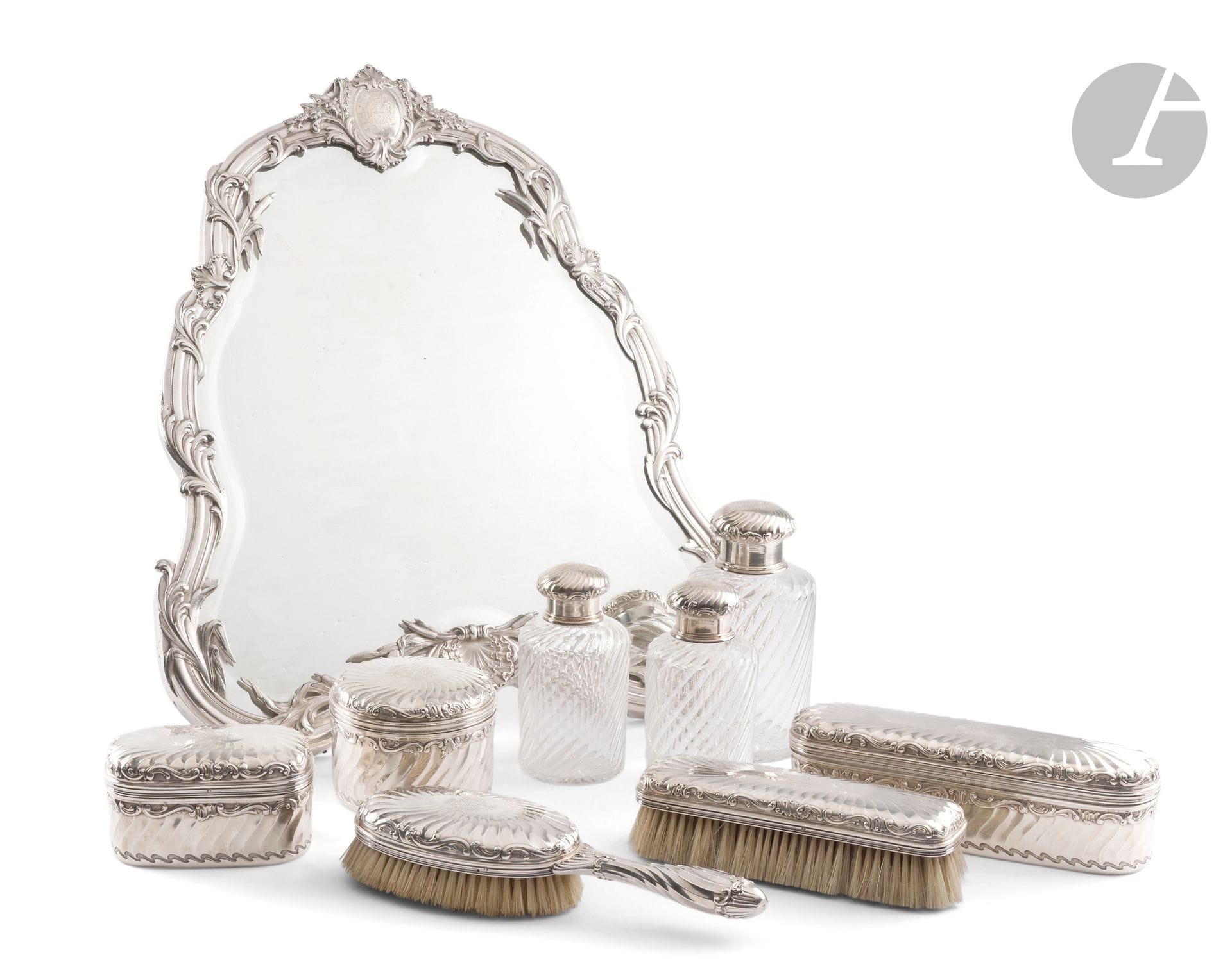 FRANCE late 19th century
Glass and silver toilet set consisting of a large table mirror, three silver-mounted glass flasks, two brushes and three boxes with vermeil interiors.
Minerve hallmark
Goldsmith: BOIN TABURET
Gross weight: 5764g - H. of mirror: 49cm - W. 41cm
Condition: one bottle glass damaged
