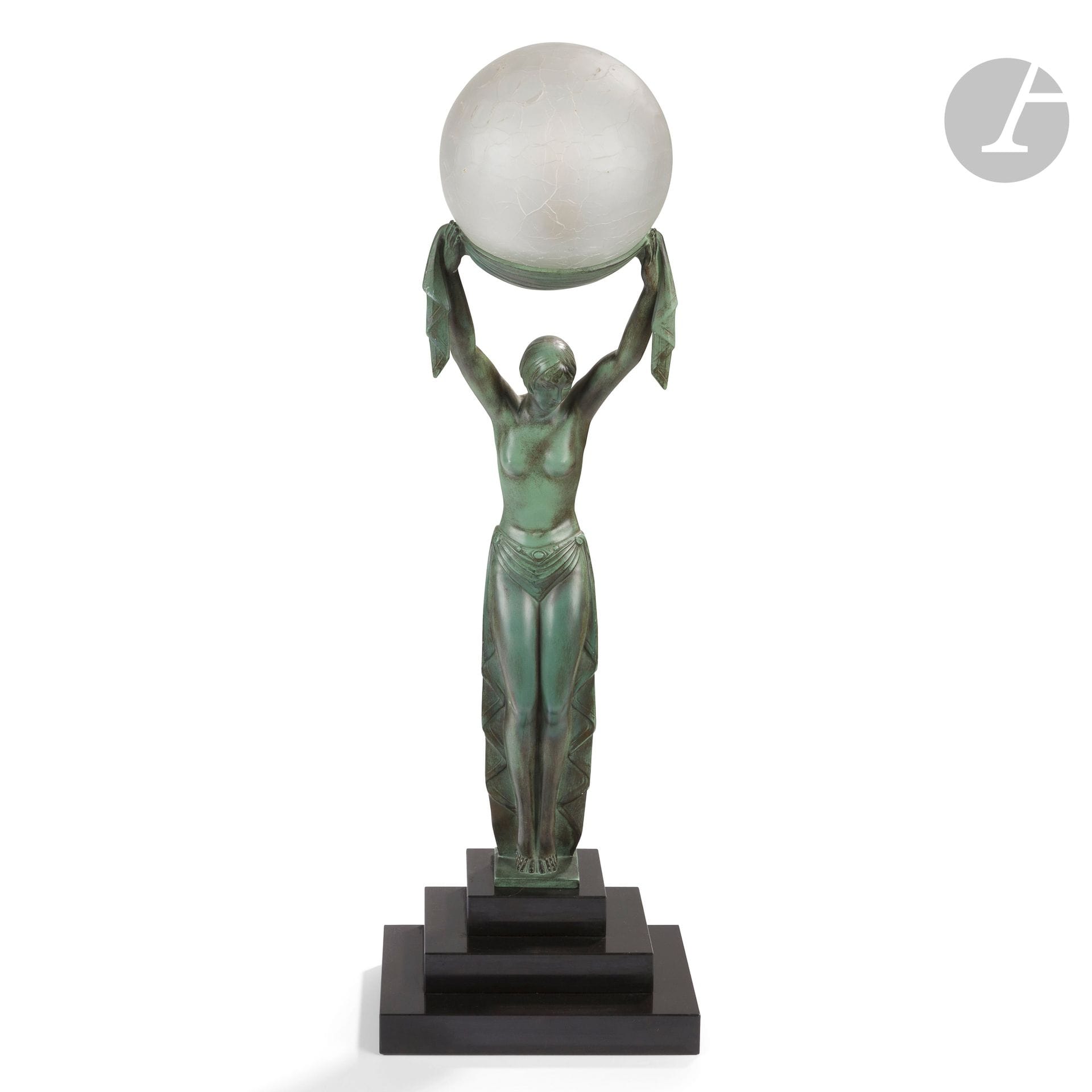 FAYRAL (1892-1962) (PIERRE LE FAGUAYS, DIT) SCULPTOR &amp; MAX LE VERRIER (1891-1973) PUBLISHER
Vérité
Important sculpture-lamp. Antique green patinated regula. The spherical bulb-holder in crisp glass. The stepped base in black marble. Worn patina. Signed FAYRAL, marked LE VERRIER and bears the circular publisher's stamp. Total height: 68cm