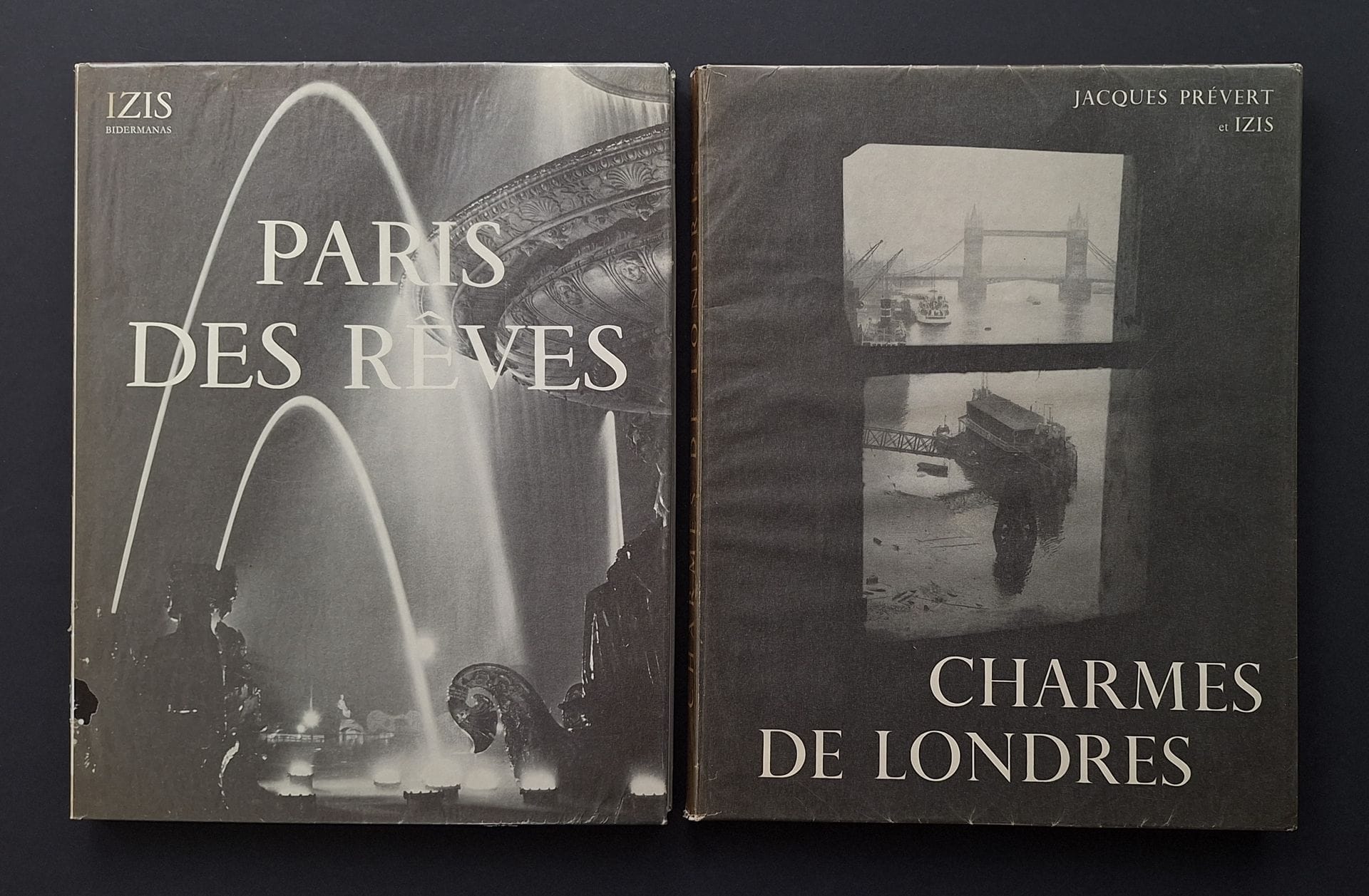 IZIS (Israëlis Bidermanas, dit) (1911-1980) 
Deux ouvrages.
*Charmes de Londres.
La Guilde du Livre, Lausanne, 1952.
In-4 (28 x 22 cm). Édition originale numérotée. Texte de Jacques Prévert. 136 pp. Photographies superbement reproduite en héliogravure. Cartonnage d'éditeur sous jaquette illustrée rempliée et jaquette cristal conservée.
*Paris des rêves.
La Guilde du Livre, Lausanne, 1950.
In-4 (28 x 22 cm). Édition originale. 128 pp. Textes en fac-similés d'autographes de Audiberti, A. Breton, F. Carco, B. Cendrars, J. Cocteau, P. Éluard, G. Hugnet, H. Pichette, F. Ponge, J. Supervielle, etc., sur 75 photographies d'Isis. Bien complet des 3 billets de traductions en français des textes anglais d'Henry Miller. Photographies superbement reproduite en héliogravure. Cartonnage d'éditeur sous jaquette illustrée rempliée et jaquette cristal conservée.
