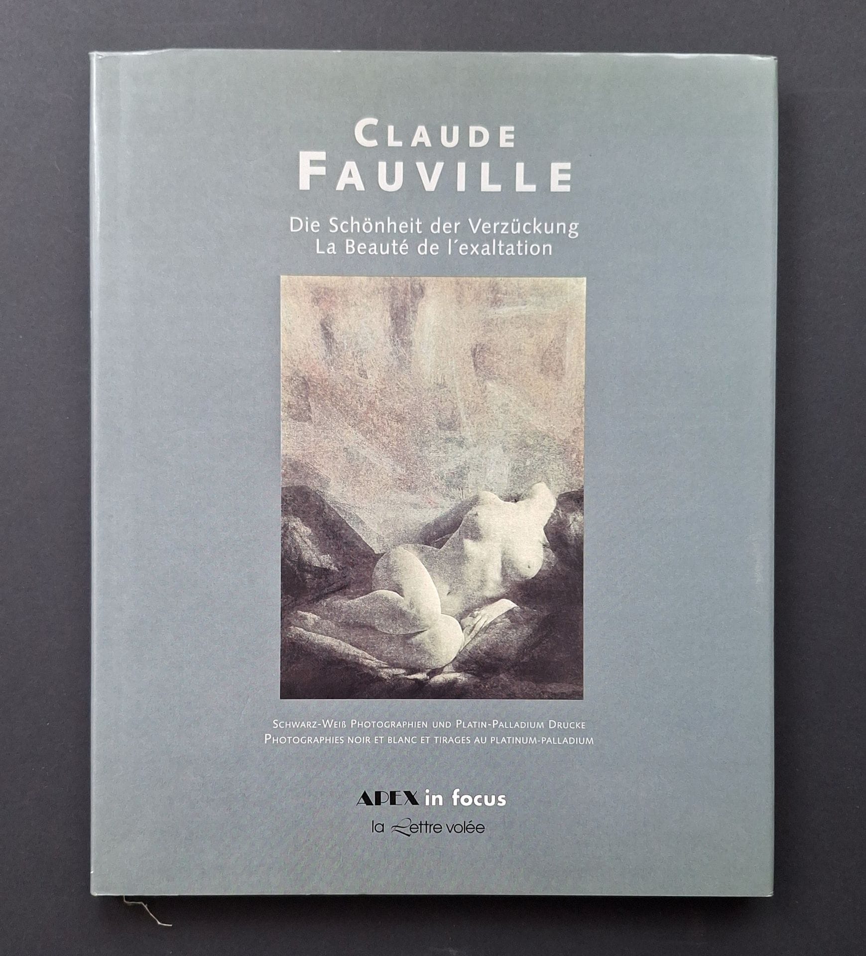 FAUVILLE, CLAUDE (1940) [Signed]
La Beauté de l'exaltation.
Die Schönheit der Verzückung.
Photographies noir et blanc et tirages au platinum-palladium.
Apex in Focus/ La lettre volée, Köln, 1996.
In-4 (27 x 21 cm). Édition originale bilingue, signée en page de titre par Claude Fauvillle. 80 pp. Textes de Bernhard Cathonnet et Dr. Reinhold Mibelbeck. 70 photographies érotiques reproduites. Cartonnage en tissu titré en creux sous jaquette illustrée.