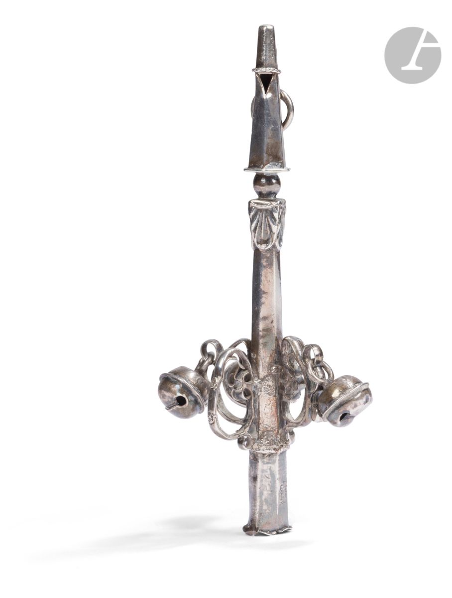FRANCE first half of the 18th century 
Silver rattle with five brackets (one missing) and three bells. The handle is extended with shells. The bell supports are composed of scrolls. The end of the handle is missing and partially torn.
Master goldsmith : Claude II HAYNAULT, received in 1726
Weight : 38 g - length : 12.5 cm