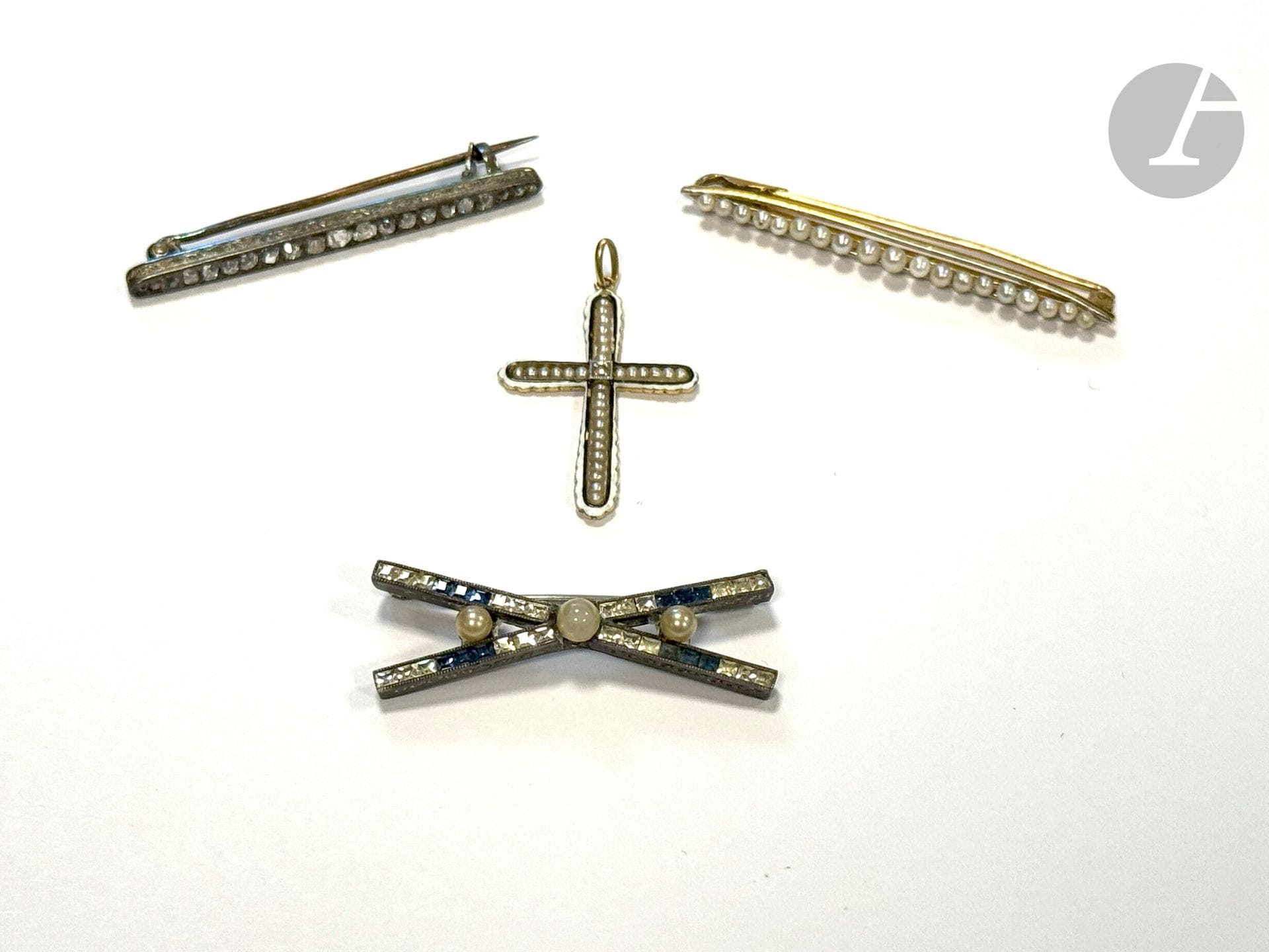 Lot de bijoux comprenant : une broche-barrette en or 18K (750), ornée de petites perles boutons ; une croix-pendentif en or 18K émaillée, agrémentée de petites perles et d'un diamant taillé en rose ; une broche-barrette en argent sertie de diamants taillés en roses (épingle en or 18) et une broche en argent ornée de pierres fantaisie. Poids de l'or : 4,8 g ; poids de l'argent : 7,3 g (manques, accidents, égrisures, chocs)