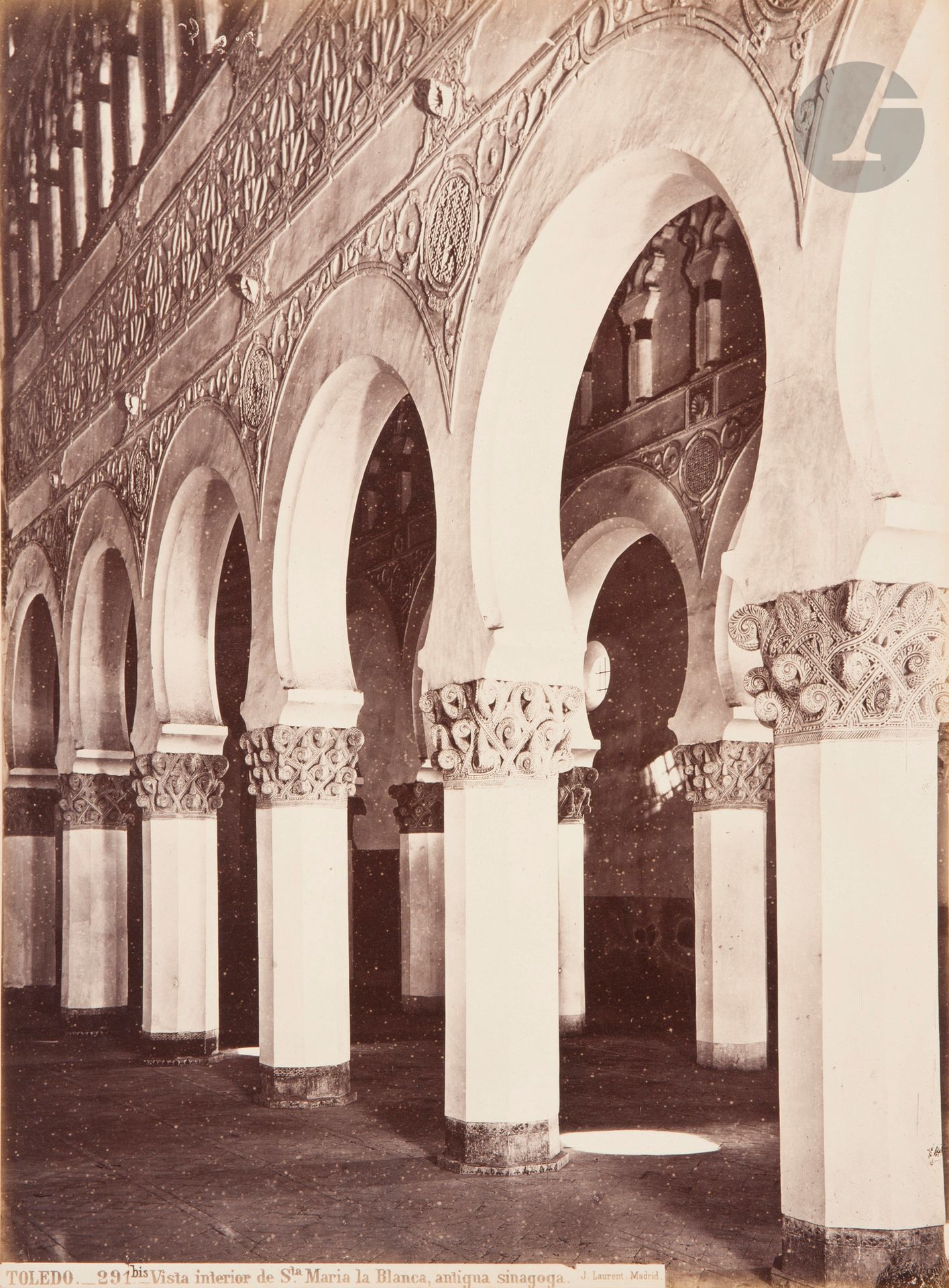 Jean Laurent (1816-1886) 
Spain, c. 1870. 
Seville. General view. Cathedral. Sacristy doors. The Conception. Cathedral cross and crucifix. Puerta del Perdon. Casa de Pilatos. Azulejos. La Giralda. El Ayuntamiento. Palacio de San Telmo. Wooden statues from the Seville Museum. 
Cordoba. General view (panorama). Puerta del Perdon. Mosque. Toledo Cathedral. Burgos Cathedral. Burgos, Plaza Mayor. El Arco de Santa Maria. La Cartuja. El Escorial. Madrid, Spain. Puerta del Sol. Plaza Mayor. Estatua de Felipe IV. Statues from the Prado National Museum. Toledo. Cathedral. San Juan de los Reyes. Puerta del Sol. Santa Maria la Blanca. Convento de San Pedro Mártir. 
Two (2) folio portfolios (54.5 x 45 cm), green percaline flap folders with title labels, consisting respectively of 21 and 39 albumen prints (including a panorama of two), mounted on cardboard. Photographer's credit, reference numbers and captions in negatives at bottom. 
Prints: 33.5 x 25 cm