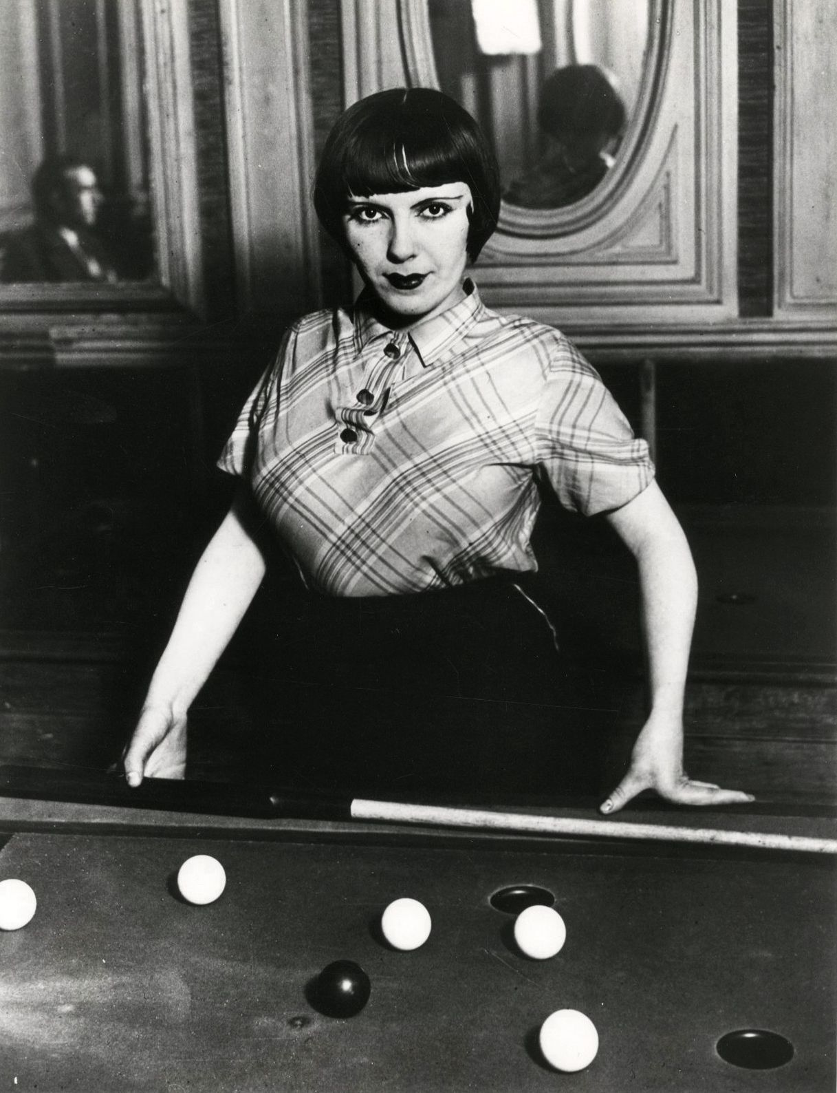 Brassaï (Gyula Halász, known as) (1899-1984)
Young woman at billiards. Paris, boulevard Rochechouart, c. 1932-1933. 
Silver print (polyester print, c. 1980), signed in ink in the lower right margin. 
Image: 27 x 21 cm / Sheet: 30.5 x 24 cm