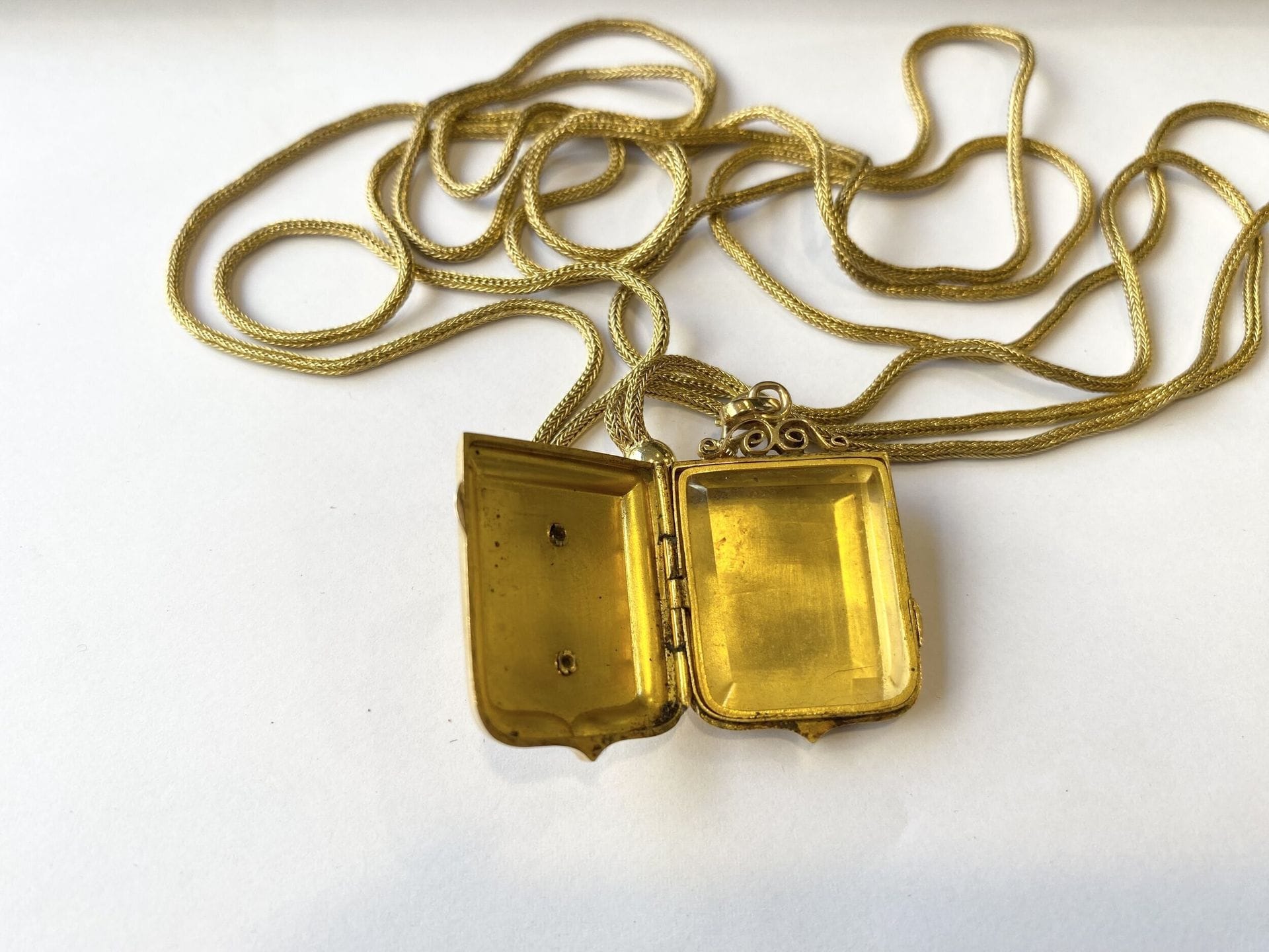 Pendentif porte photo en or jaune 750/°°° en forme d'écusson, monogrammé. 

Joint une chaine en or jaune tressé 750/°°°.

Poids brut. :  44 g



Frais acheteur pièces et lots en or : 9,6% TTC -  8% HT 



Frais acheteur lots d'argenterie : 20% TTC - 16,67% HT