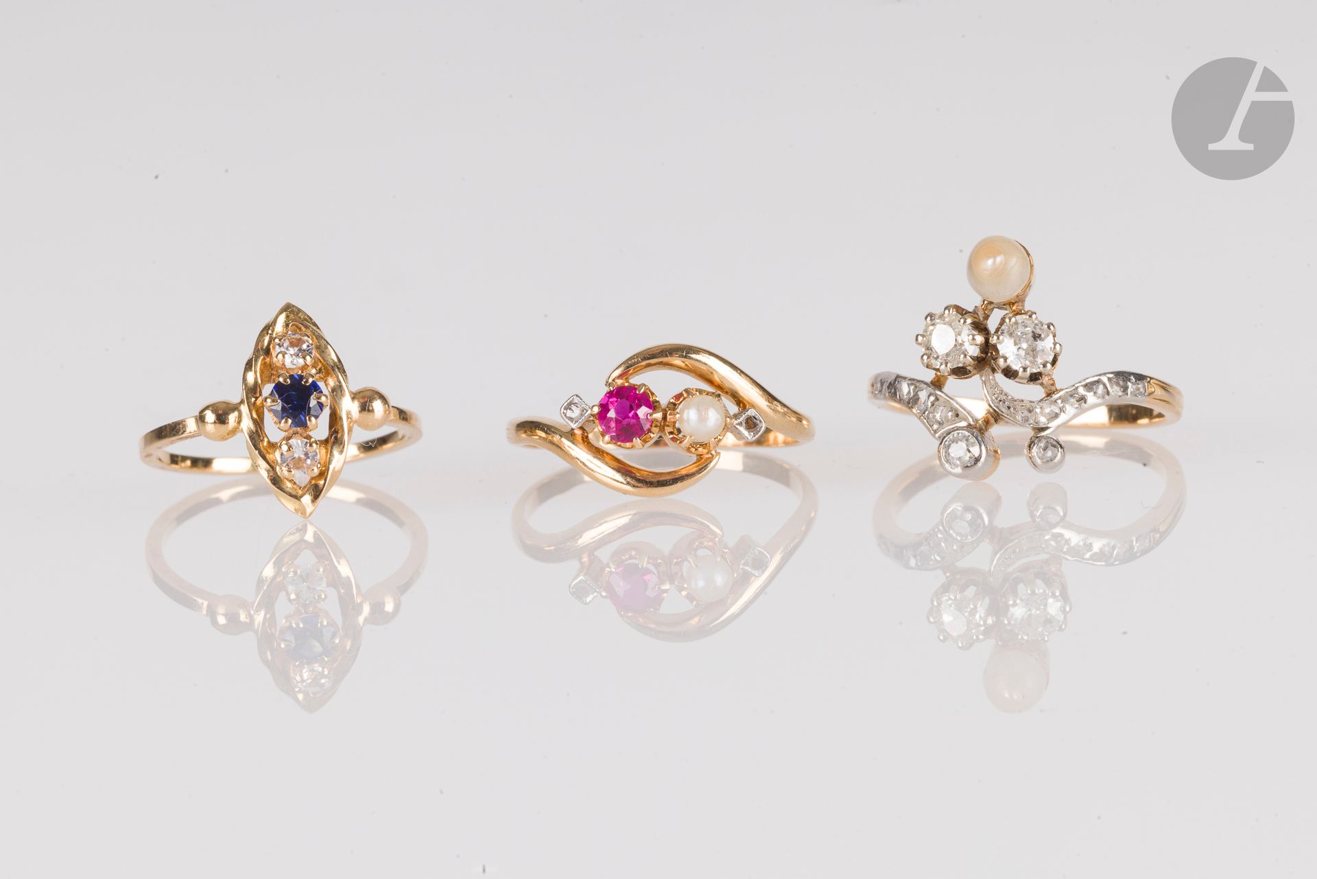 Lot de 3 bagues en or 18K (750) : la 1ère sertie d'un saphir et de diamants ; la 2ème ornée de diamants de taille ancienne ou taillés en roses et d'une perle ; la 3e ornée d'un rubis et d'une perle. Poids brut : 8,6 g