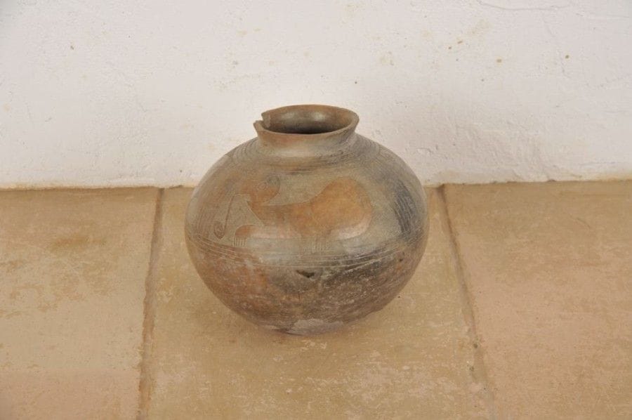 Vase globulaire orné d’une frise de trois félins laissés en réserve sur un fond quadrillé.  Une volute s’échappe de leur gueule. Terre cuite brune à engobe rouge au décor gravé. Traces de brûlure. Culture Cuasmal, Équateur, 800 - 1500 ap. J.-C. H : 17 cm - Diam : 16 cm État : cassures sur le col. Engobe écaillé avec manque sous le vase.