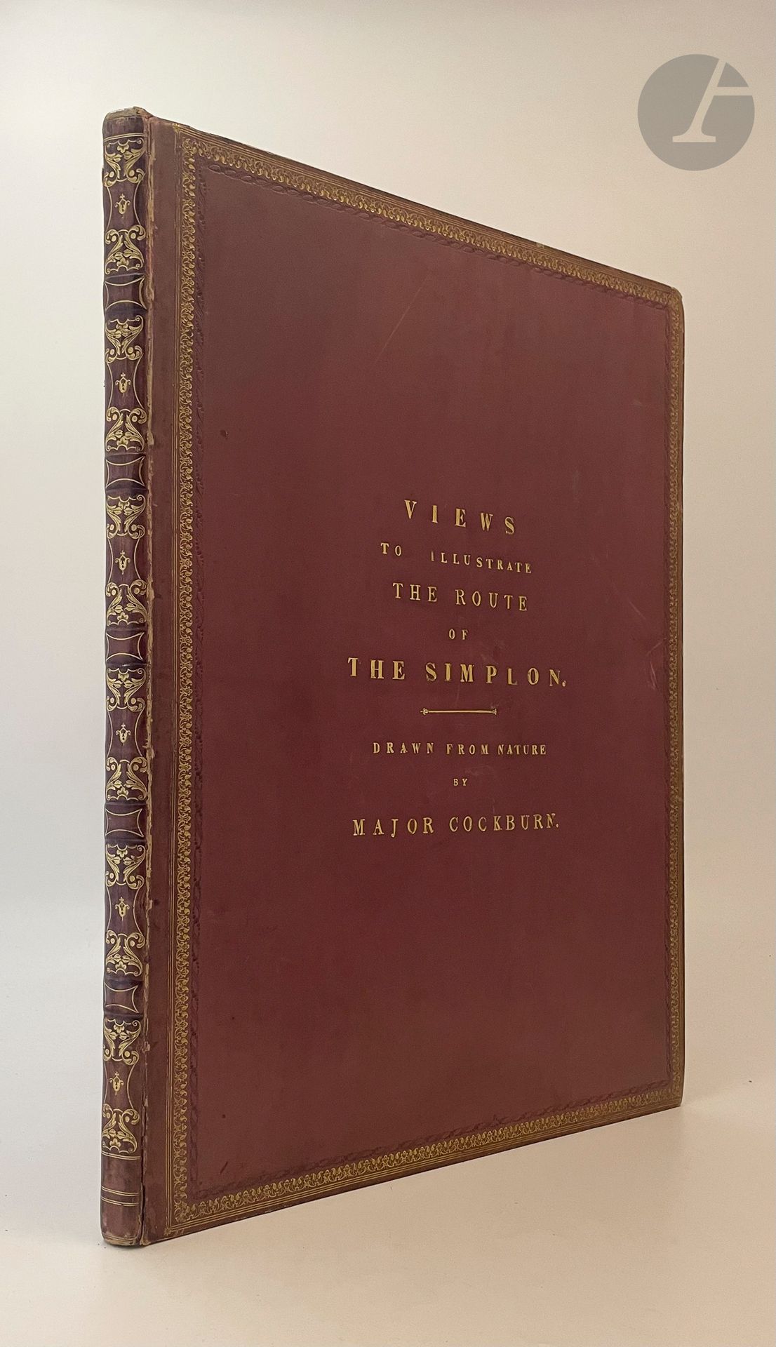 COCKBURN (James Pattison)
Views to illustrate the route of the Simplon.
Londres : Rodwell et Martin, 1822. — In-folio, veau violet, roulettes à froid et dorée en encadrement sur les plats, titre en lettres dorées au centre du premier plat, dos à faux nerfs orné, roulette dorée intérieure, tranches dorées (William Potter).
Édition originale peu courante de cet album illustrant la nouvelle route de Simplon voulut par Napoléon pour renforcer la défense de l'Italie du Nord, considérée comme la première route carrossable des Alpes.
L'ouvrage comprend 50 planches lithographiées par J.D. Harding et C. Hullmandel à partir des dessins faits d'après nature par James Pattison Cockburn. La première représente l'église construite à Ferney par Voltaire et la dernière le Lac majeur.
Très bel exemplaire relié dans les années 1830 par William Potter, provenant des bibliothèques du baron Newborough et de Bourlon de Rouvre.
Fente de quelques centimètres à une charnière, quelques frottements d'usage, coins légèrement émoussés. Rousseurs éparses.
Provenance : Baron Newborough, avec ex-libris. - Bourlon de Rouvre, avec ex-libris.
