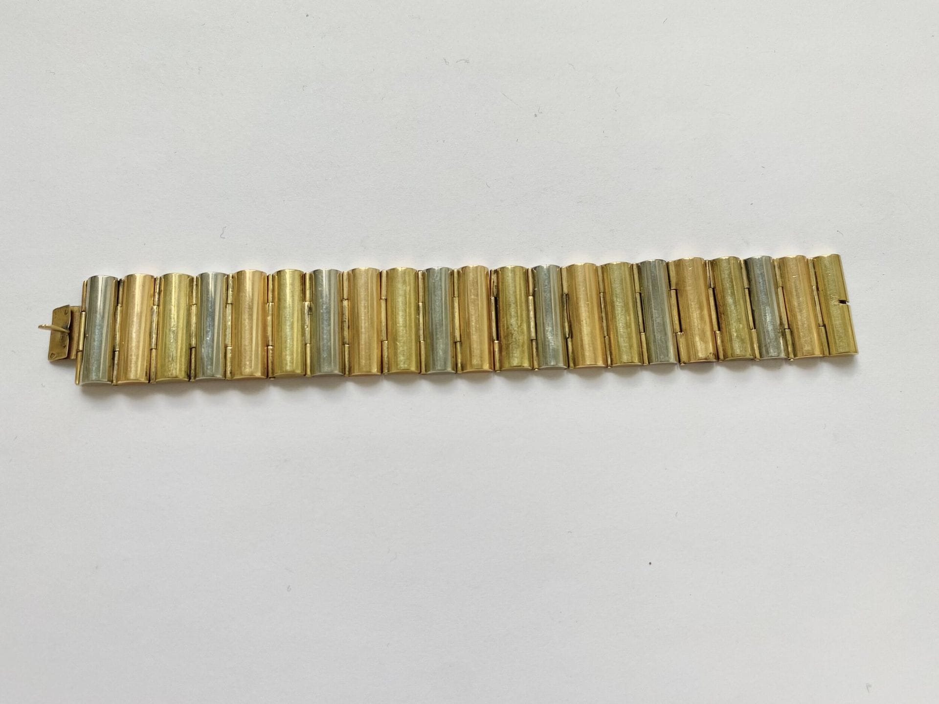 Bracelet articulé en or 3 tons 750/°°°. Années 50. 
Poids. : 76 g