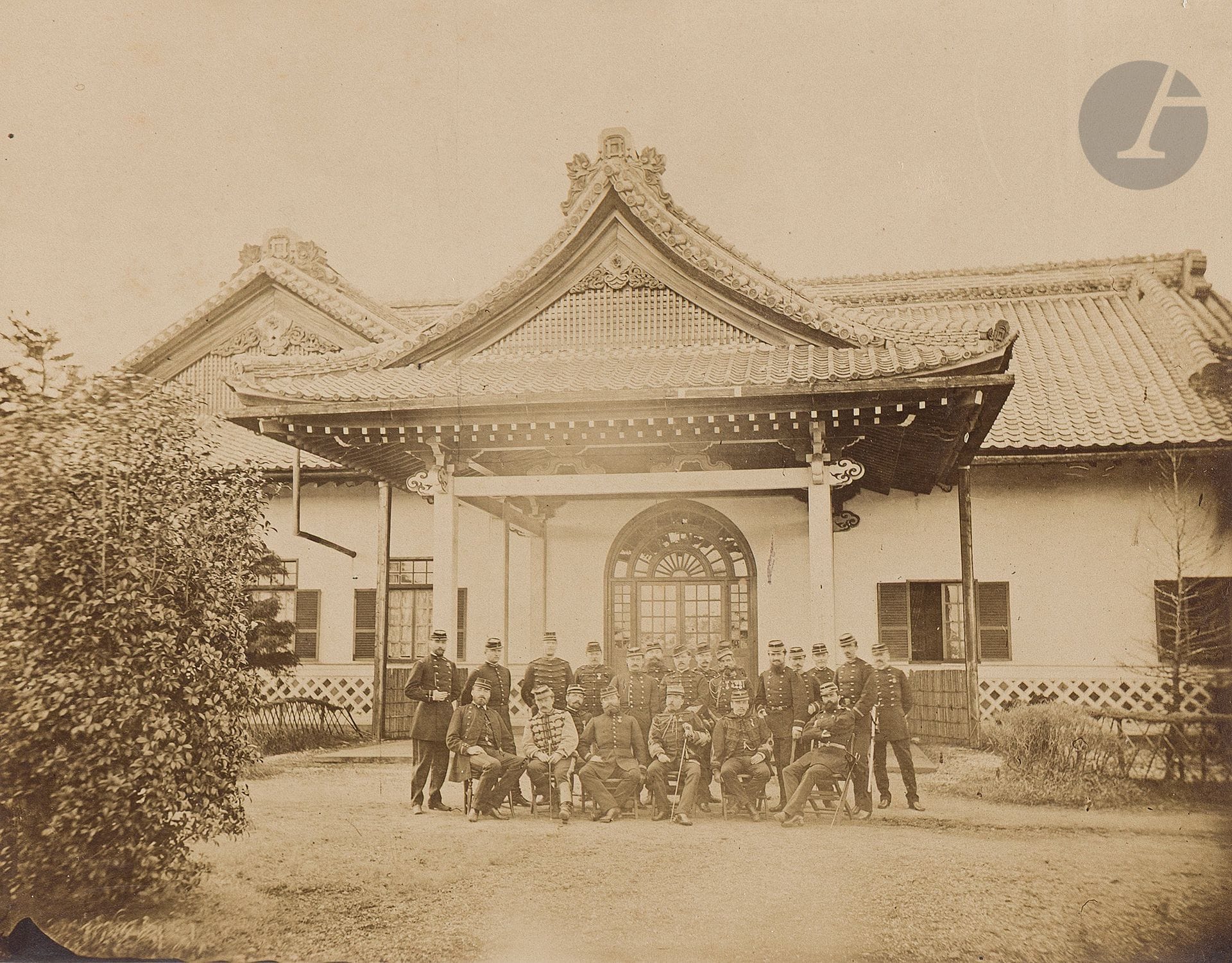 Abel Guérineau (1841-1925)
Four black-and-white photographs, albumen prints
- The first enhanced with Indian ink, titled 井伊邸内延 - Ii tei-nai en - "In the extension of the Ii clan estate". On the mount, bottom right, pencil inscription "My garden in Tokio", and left "Indian ink photo". 20.7 x 28.6 cm. - The second, in oval form, depicts a Buddhist monk at the entrance to a Mukaikaramon. On the paper support, lower left, the Indian ink inscription "Salon de 1883" and the artist's initials. 26.5 x 21.7 cm. - The third depicts two men standing at the bottom of a large waterfall. On the paper support, lower right, the Indian ink inscription "Near Nikko (Japan)". 27.5 x 21.6 cm. - The last depicting the second French military mission to Japan (1872-1880). On the paper support, lower right, the inscription "Mission militaire de France au Japon à Mr Guérineau le chef de la mission - Souvenir affectueux Lt - Colonel Munier Japon 1877". 20.7 x 26.5 cm. Stain.