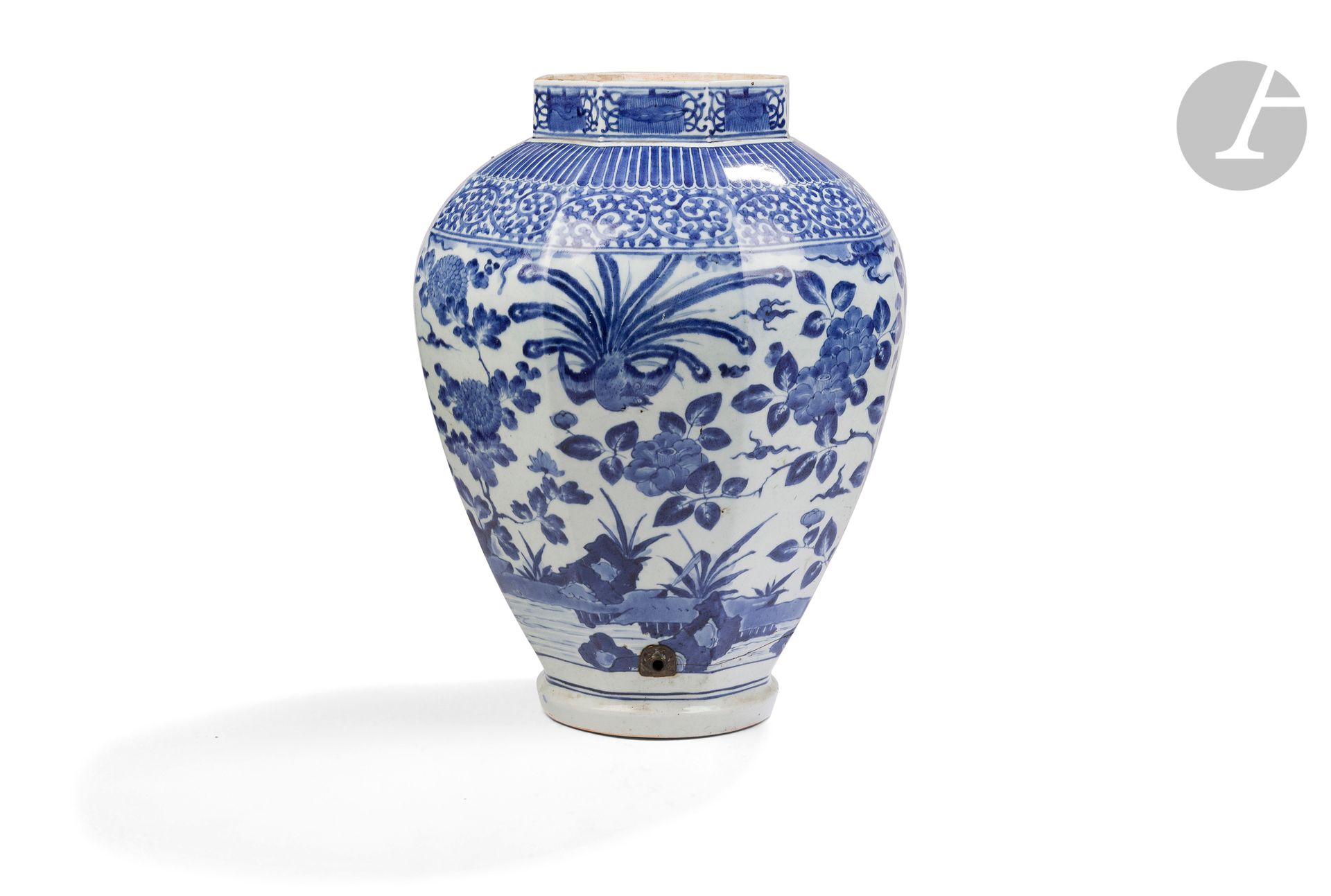 Large blue and white porcelain vase, Japan, Arita, 17th century
Octagonal in shape, decorated on the body in blue underglaze enamel with phoenixes, peonies, chrysanthemums and rocks. Above, on the shoulder, a band of tako karakusa, then another band of stylized lotus petals, on each side of the neck a decoration alternating leaf and cloud on a scroll background. A hole has been drilled at the bottom for a metal frame to transform the vase into a fountain. 
Height: 50 cm
Fel around the hole under the foot, lid missing.
