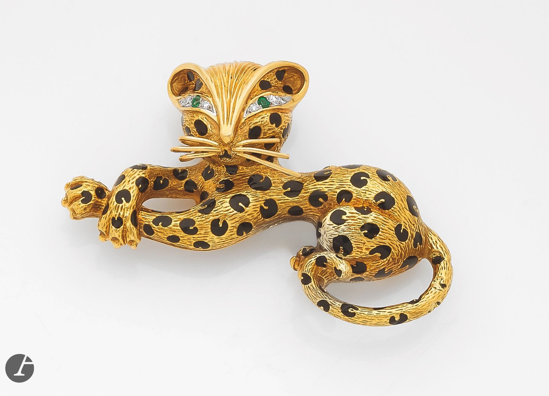 FRED 
Panther brooch-clip in 18K (750) gold, the coat highlighted with enamel spots, the eyes in emeralds and 8/8 diamonds. Signed. French work. Dimensions: approx. 6 x 3.3 cm. Gross weight: 26.5 g (enamel missing)
