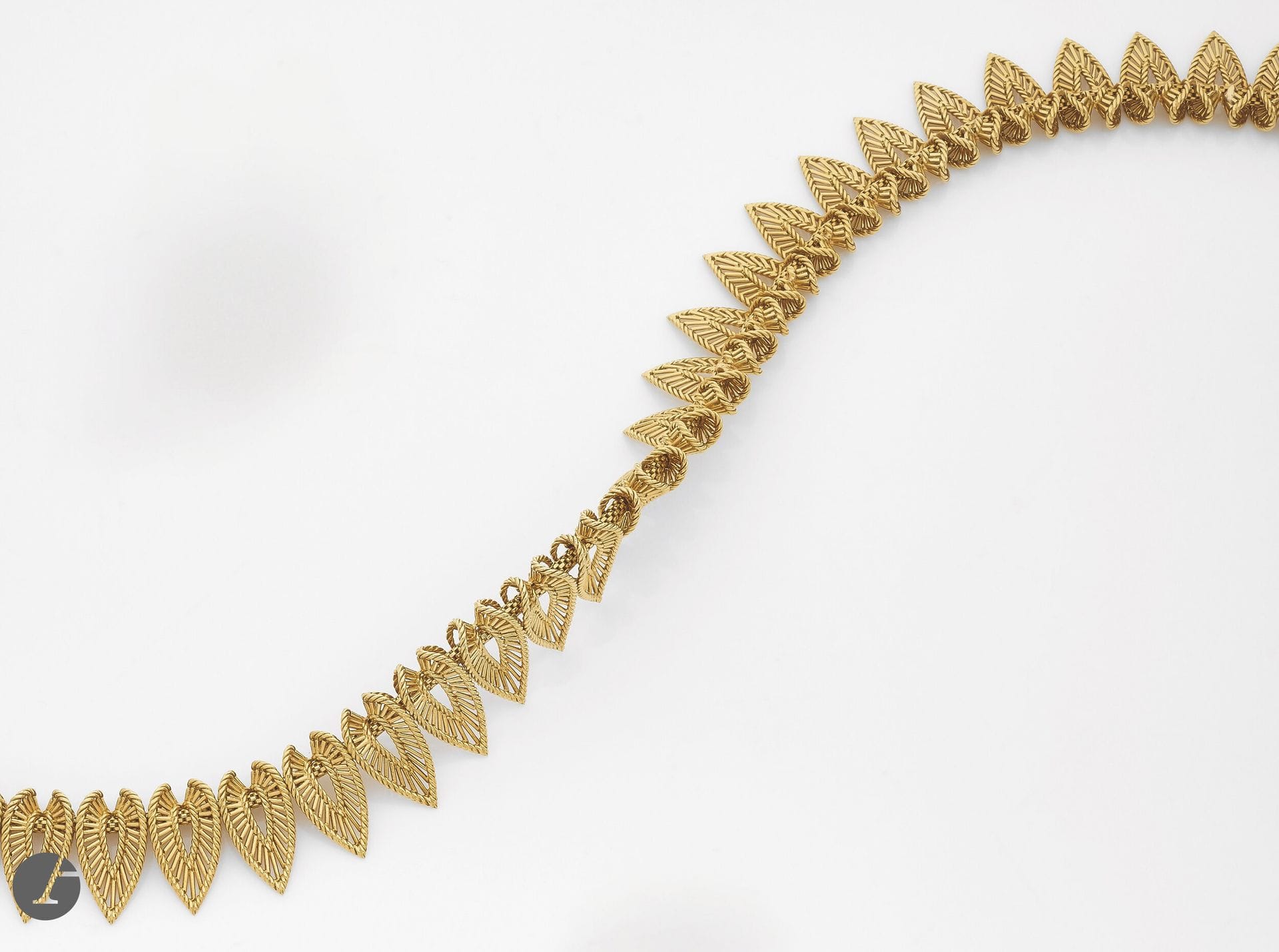 Collier en fils d'or 18K (750), articulé de feuilles. Travail français des années 1950. Longueur : 42 cm environ. Poids : 96,7 g