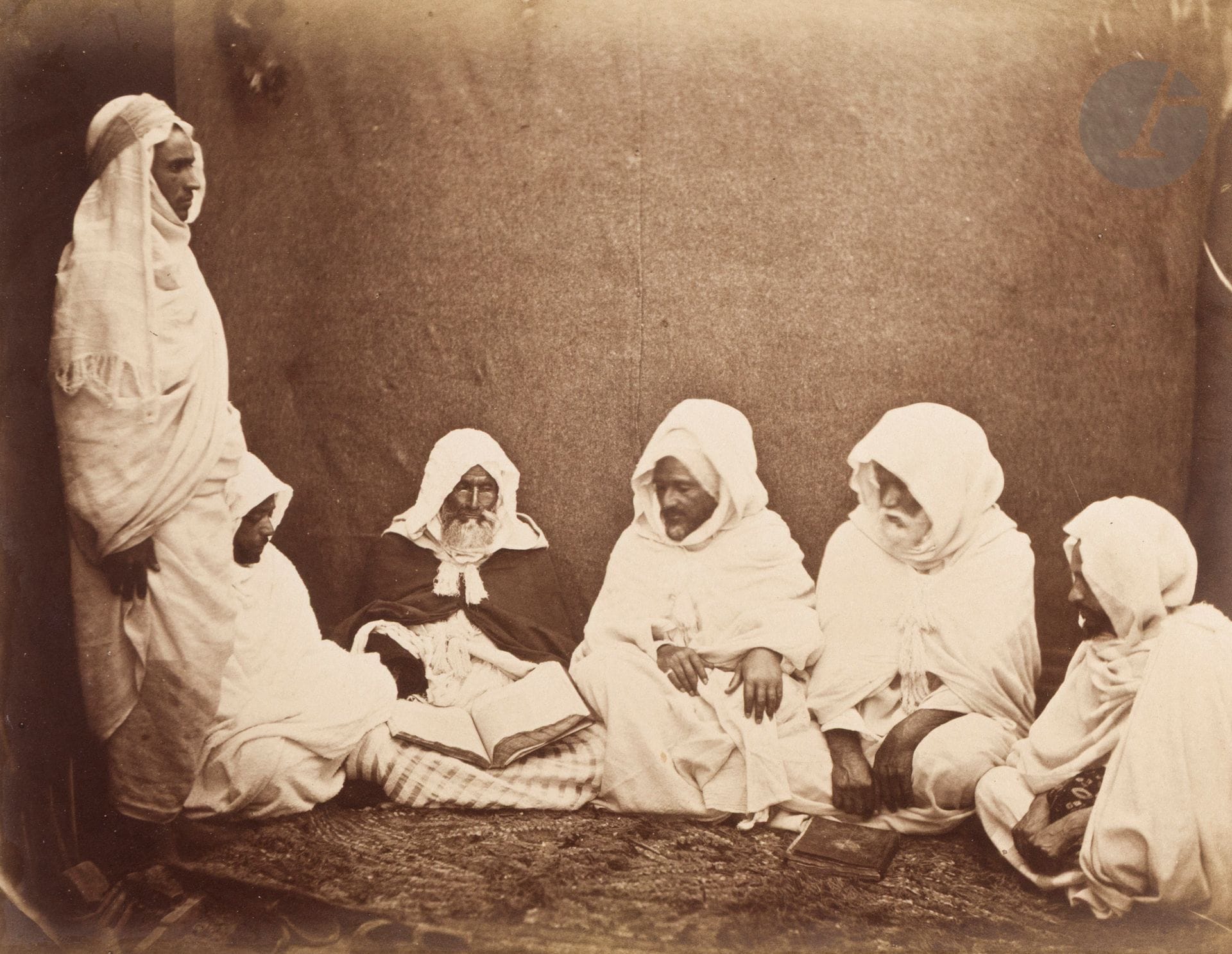 Félix-Jacques Moulin (1802-1879)
Algérie, c. 1856-1857.
Vues d’Afrique.
Alger. Grande Mosquée, rue de la marine. Palais de Constantine. Oasis de Biskra. Tombeau de la chrétienne. Tebessa. Ancien temple de Minerve. Bône. Monument érigé en l’honneur de Saint-Augustin. Philippeville. Mosquée. Évêque d’Alger. Jules Gérard. Tlemcen. Medjeles. Les Amins avec M. Viguier. Musiciens. Danse des Biskris. Oran. Partie d’échecs. Aïssaoua.
Album in-folio oblong en plein maroquin vert, titré sur le dos et décoré sur les plats, composé de 23 épreuves sur papier albuminé, contrecollées sur cartons et protégées par des serpentes. Légendes à l’encre ou sur étiquettes aux versos des montages. 
Format moyen des épreuves : 19 x 25,5 cm