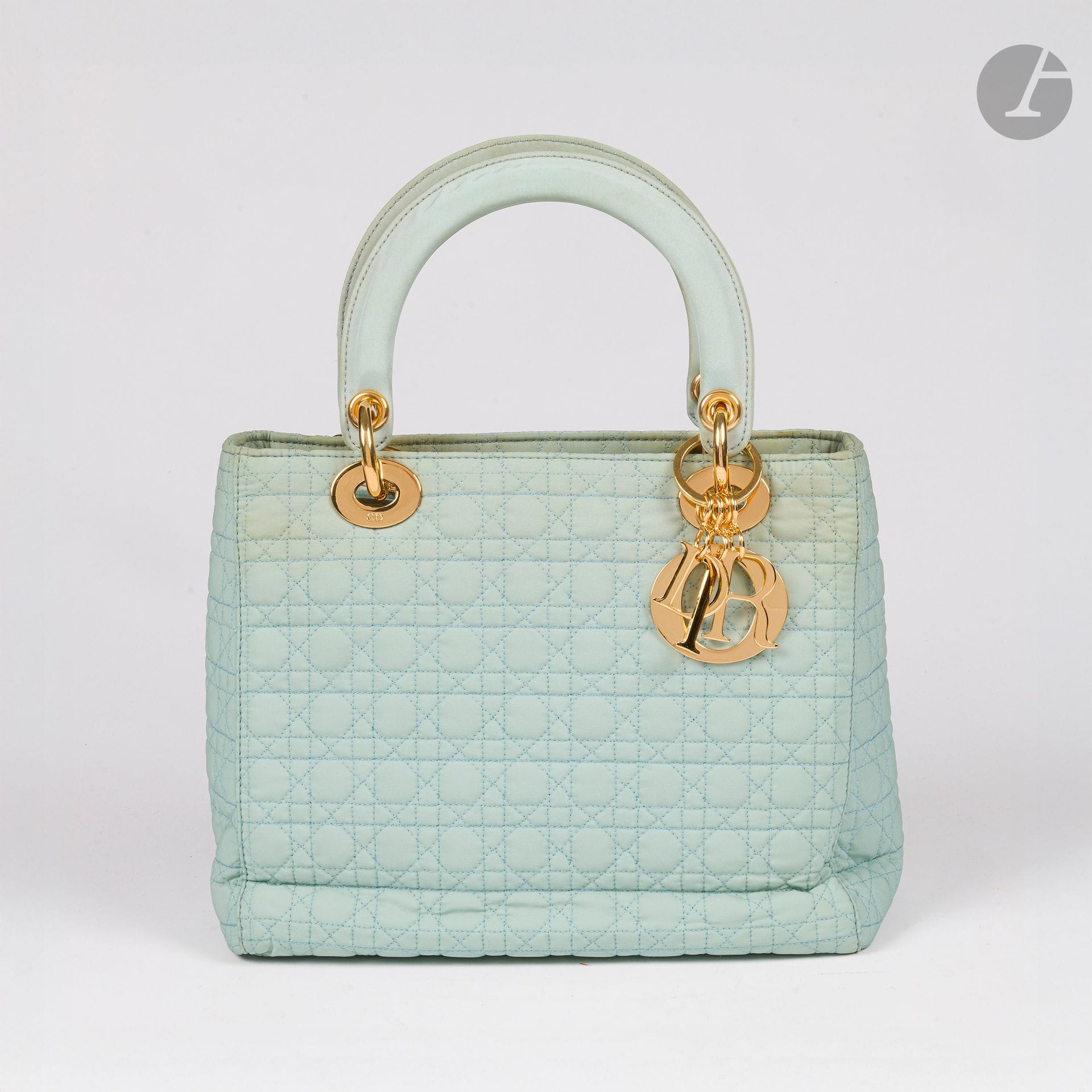 CHRISTIAN DIOR
LADY DIOR bag in water green or sky blue nylon with cane stitching, gold metal trim and charms. 23 x 20 x 10 cm. In bag (discoloration and stickiness, dirt and marks, as is).