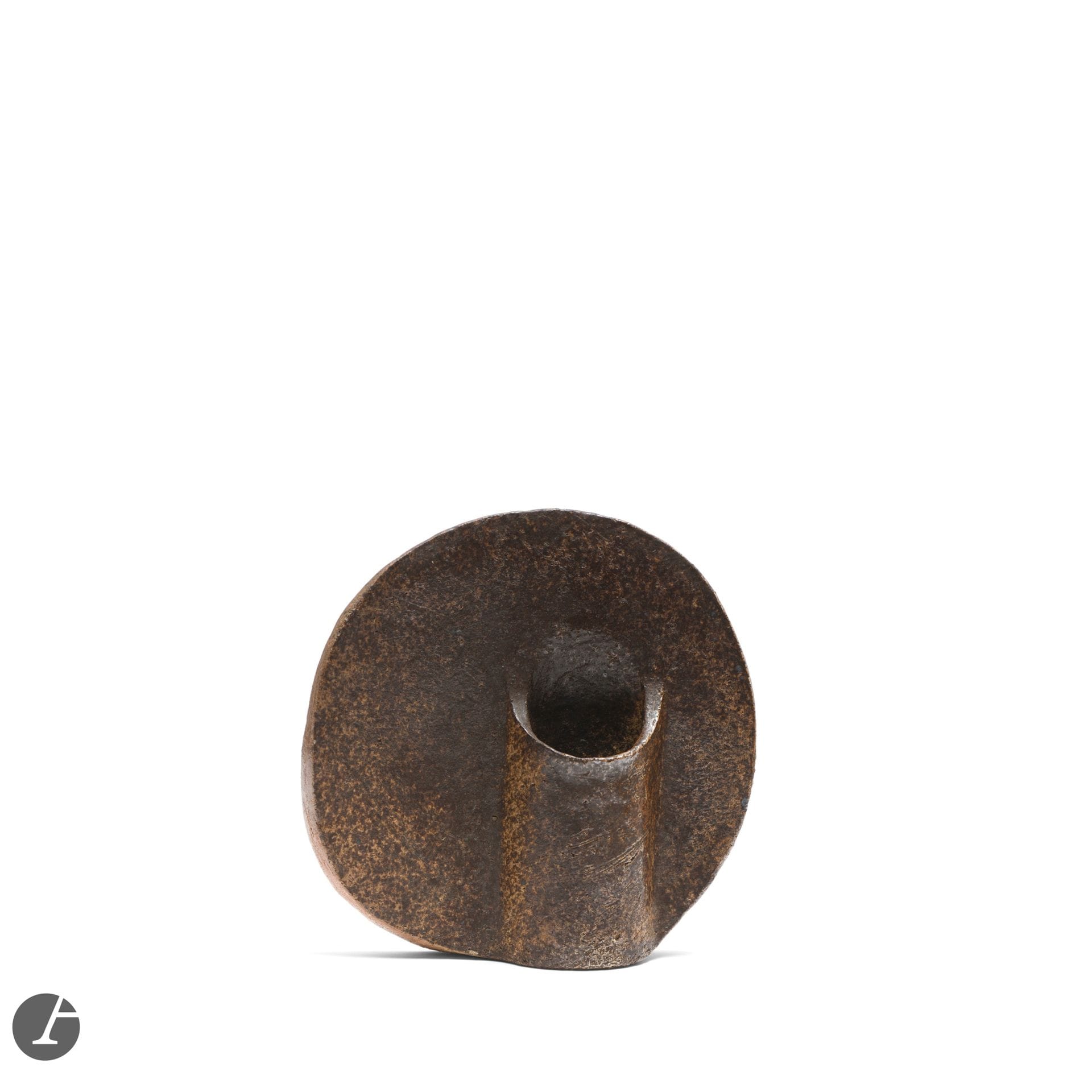YVES MOHY (1928-2004)
Untitled, 1977
Bouquetière.
Stoneware proof.
Signed and dated MOHY (19)77 on the back of the base.
Height: 19.5cm

Bibliography:
Philippe Chambost, Pascal Marziano and Arnaud Serpollet - 1947-2017, 70 ans d'expression céramique française - Éditions Les livres de l'îlot, Neuvic, 2020. Our work reproduced on page 217. 


With a dual training in architecture at the École des Beaux-Arts in Paris and in ceramics at the École des Métiers d'Art, Yves Mohy settled in La Borne with his wife Monique Lacroix (1931-2024) in 1955 - a village with a pottery tradition, the key to a return to the earth, which he visited several times as a student and which revealed to him the importance of stoneware in his artistic approach. There, with Jean and Jacqueline Lerat (1913-1992) &amp; (1920-2009) and Élisabeth Joulia (1925-2003) in particular, he was to contribute to a renewal of the history of this medium. Initially focusing on utilitarian pieces, his ceramic production soon turned to sculptures and highly constructed pieces. Like the Lerats, Yves Mohy questions shapes, volumes, light, materials and objects. Their shared interest in contemporary creation, their many exchanges and the exhibitions they visit are no strangers to this reflection, which resonates undeniably with Mohy's training as an architect, and from which increasingly sculptural and architectural pieces are born.
Yves Mohy works with stoneware in all its purity, highlighting the material for its own sake in a play of shapes by working on the [face reading]. He assembles slabs of geometric cross-section - square, rectangle, triangle - into solid-looking constructions - not without a few cracks, scarifications or soft edges, which show that his work remains rooted in a sensitive approach. It is precisely this balance that makes his work so compelling. Their power is reflected in the impression of monumentality they exude - even though their dimensions rarely exceed 70 centimetres in height. Our Lentille vase is a perfect illustration of Mohy's work as a sculptor-ceramist: the vase is no more than a pretext for experimenting with the assembly of two circular flat surfaces which, when united, bring the material itself, its monumentality and the play of color and light on its surface, into the realm of contemporary creation. Mohy plays with the vocabulary of both sculpture and painting, building up his ceramics through the juxtaposition of highly constructed planes and volumes, and creating irregular surfaces through nuances of color, but also through the addition or removal of material - like his work on our Mastaba sculpture or our Architecture lamp.
Yves Mohy's one-of-a-kind creations quickly earned him a reputation for exhibiting his work in renowned galleries and for producing porcelain editions for Virebent. From the 1970s onwards, he moved regularly: to Paris, the Lot and the Hérault, before returning to the Cher. He also taught in Bourges and Limoges - in keeping with the need to pass on his art. From 1984-1985, he integrated a wide range of materials into his creations - wood, iron, slate and porcelain, among others - pursuing the quest for confrontation between forms and materials that has always driven his plastic research.