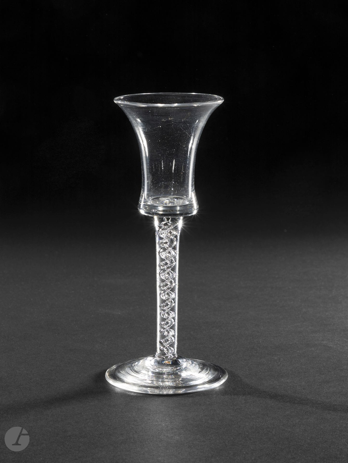 A wine glass. The inverted bell-shaped bowl. The leg with a double air twist. The conical foot. 
England, mid-18th century.
Height: 16 cm

Provenance :
W.W. Warner Antiques 2008