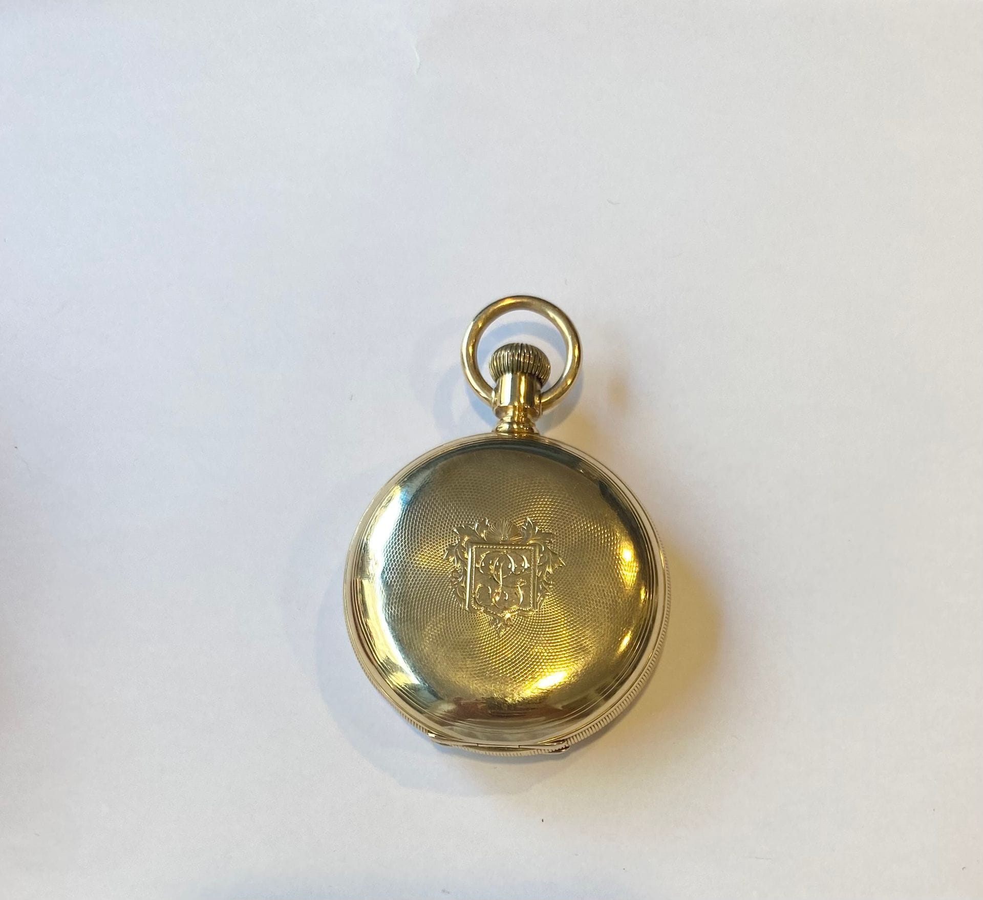 American Waltham W. Co. Montre à gousset en or 750/°°° à décor guilloché avec un monogramme dans un écusson. 
Poids brut. : 138,77 g