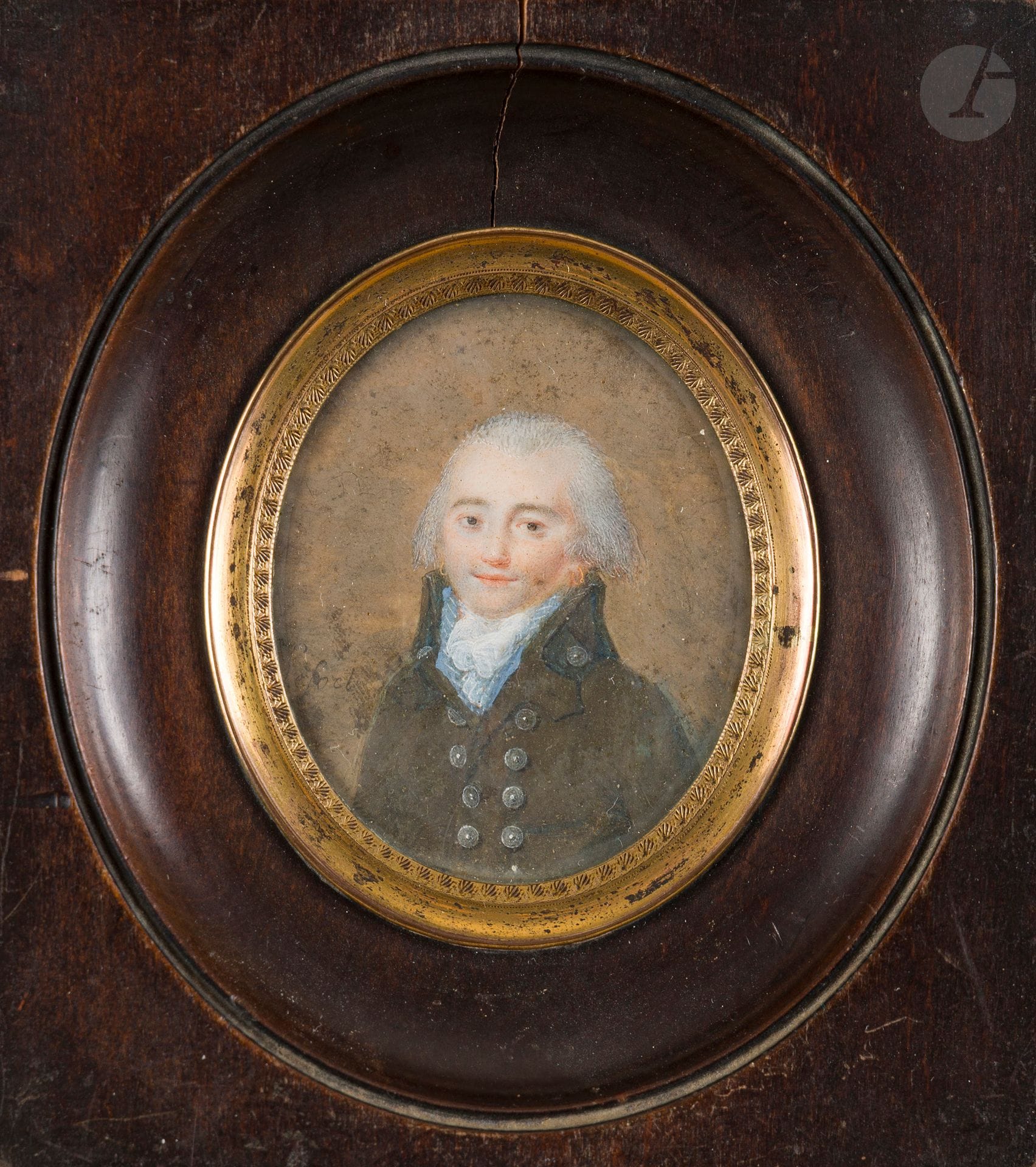 LEFORT (active 1791-1816)
Half-body portrait of a man facing left in a brown suit with large metal button scale and blue vest, powdered hair and ear ring, circa 1791-1795.
Miniature on oval ivory. Signed on the left: Lefort. 
Sight 5.7 x 4.7 cm; burnished wood frame rect. 11.5 x 10.2 cm 
(stains; frame split at top).
A painter of miniatures, Lefort exhibited ten of his works at the Salon de la Jeunesse in 1791, and by 1816 was established in rue des Fossés-du-Temple, Paris. His miniatures are very rare today.