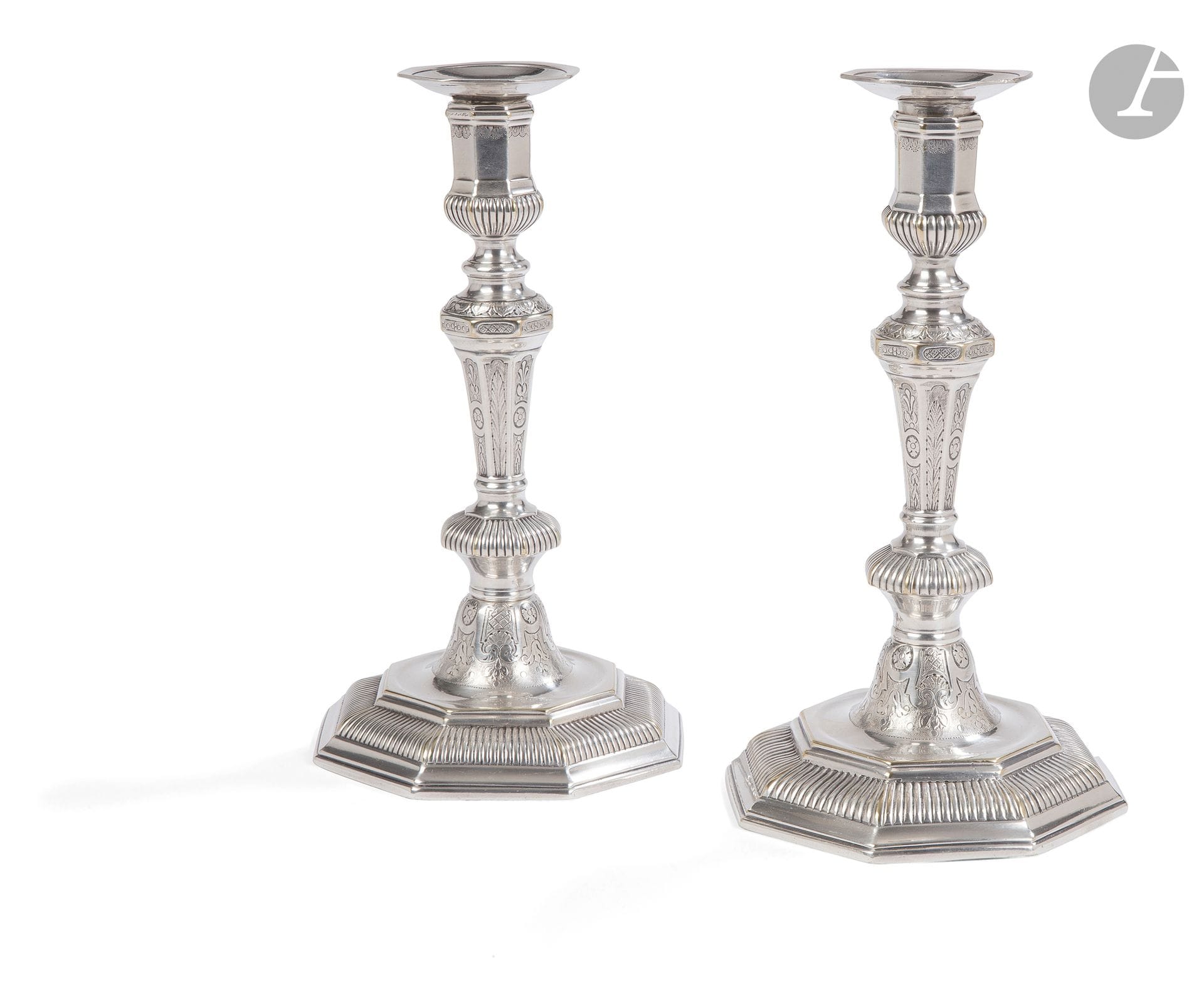 Pair of silver-plated bronze torches, the tapered shaft resting on an octagonal base, decorated with stylized foliage and gadroons; (later silver plating).
Regency period.
H. 24 cm