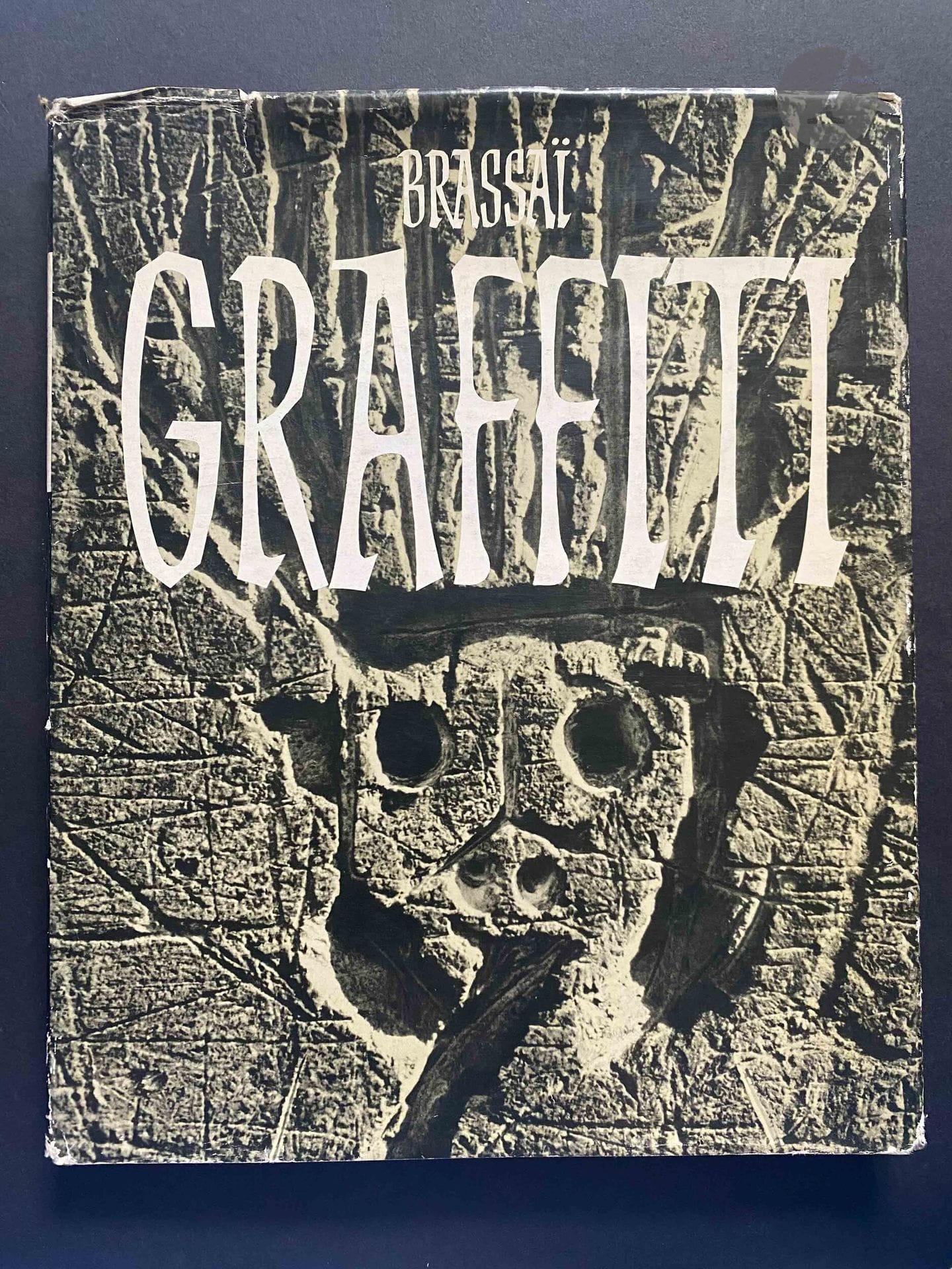 BRASSAÏ (GYULA HALÀSZ, DIT) (1899-1984) [Dédicacé à Jean Dieuzaide]
Graffiti.
Les éditions du temps, Paris, 1961.
In-4 (29 x 23 cm). Édition originale dédicacée et signée par Brassaï à Jean Dieuzaide en 1965. 105 photographies superbement reproduites en héliogravure. Reliure en tissu noir sous jaquette illustrée (déchirures).