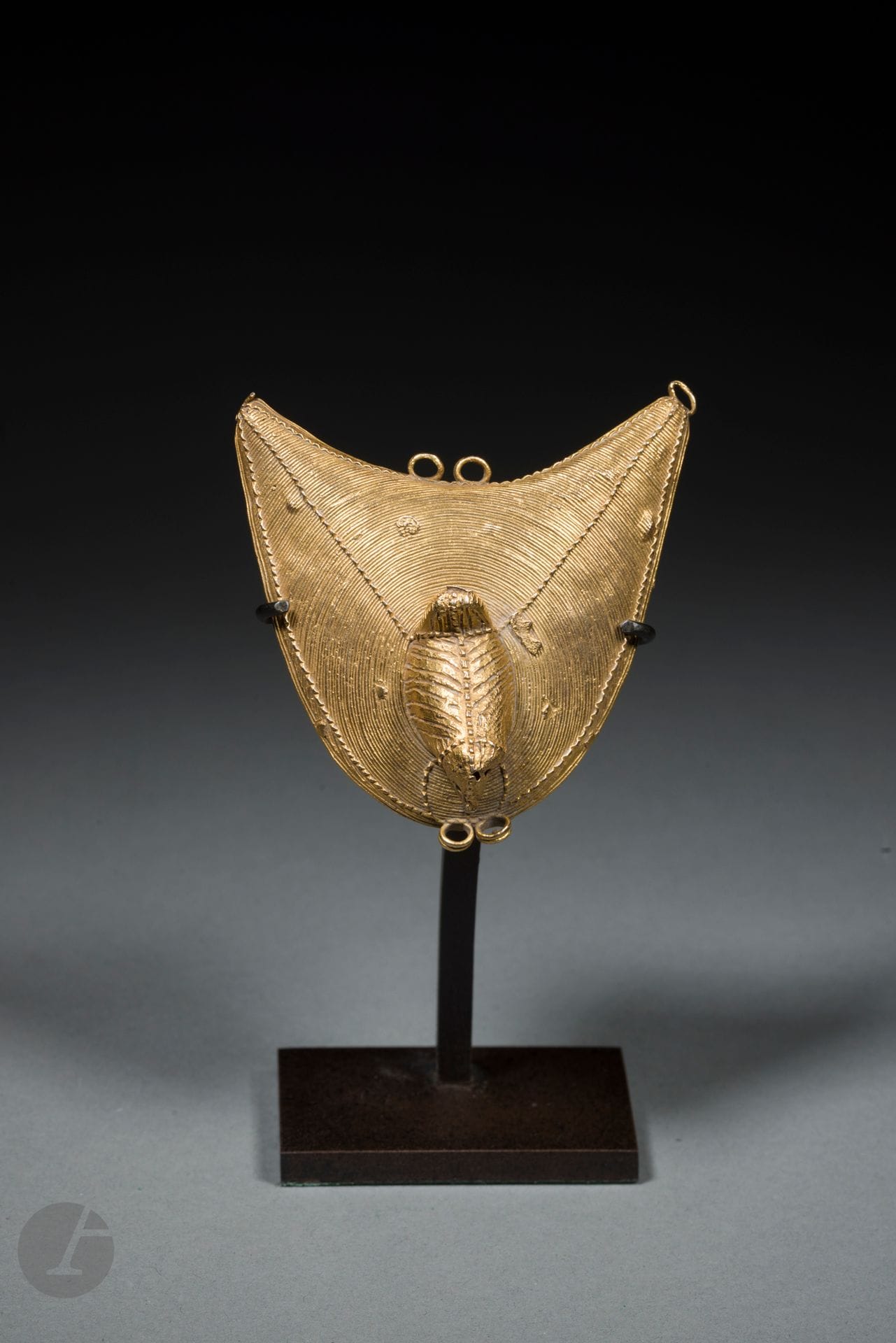 A beautiful filigree fetish gold ornament topped with a delightful little bird. 
Akan, Ivory Coast or Ghana
19th or early 20th century
Alloy of 13.31-carat gold, copper, silver and zinc, missing loop at upper left.
H. 7 cm

Provenance :
Christian Humann Collection, Paris
Transmitted by descent.