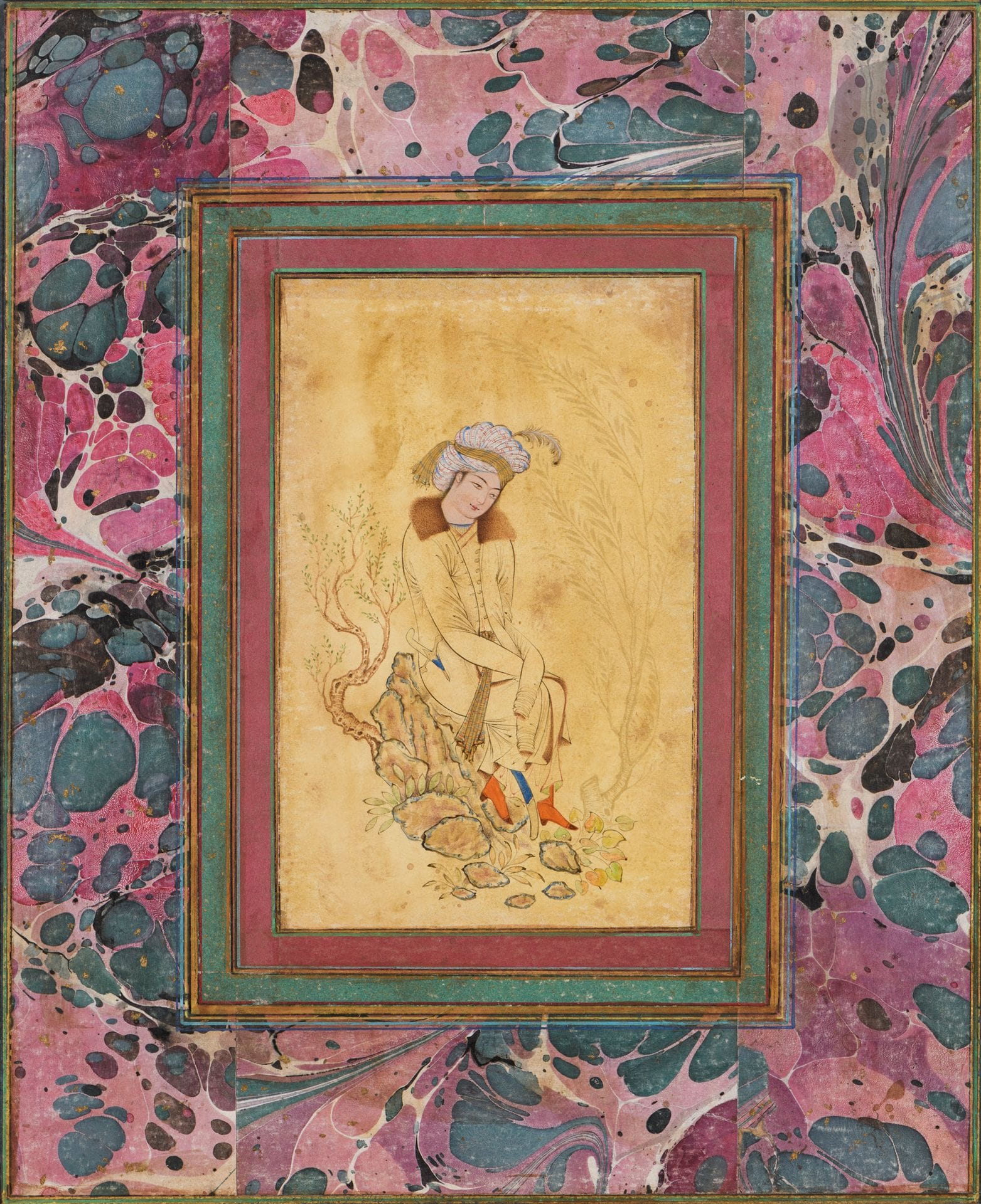 Man seated on a rock, Safavid style, Iran qâjâr, 19th century
Ink, gold and gouache on paper depicting a turbaned man wearing a long-sleeved coat with fur lining and collar, seated on a rock framed by two trees. Mounted as an album page on card stock painted with an ebru decoration and colored borders.
Dim. drawing: 14.5 x 8.8 cm; page: 28.3 x 22.6 cm
Small stains and wear.