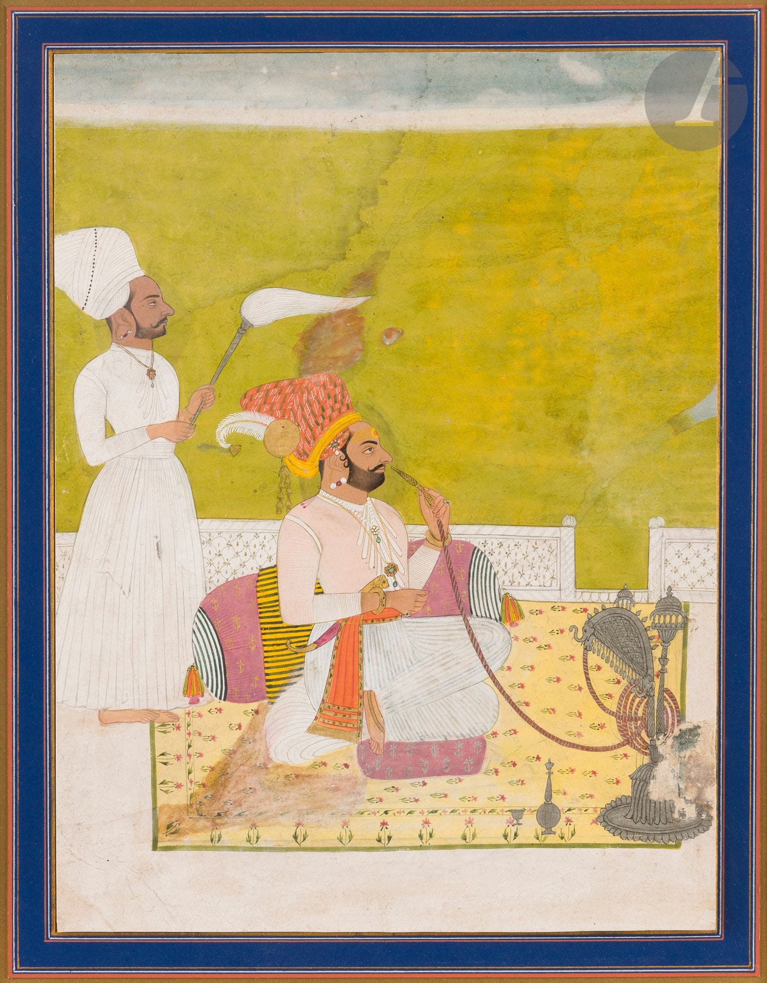 Raja smoking a huqqa, North India, Rajasthan, Jodhpur, late 19th century 
Gouache, gold and silver on cardboard depicting a raja smoking a silver huqqa with elephant protoms. He is seated on a terrace against a cushion, fanned by a servant wearing a prominent turban like his master. Frame. 
Painting size: 29 x 21.9 cm 
Stains, mending, overpainting, heavy wetness, accidents, mounted gouache. 
Two sketches in black ink on paper are enclosed, the first enhanced with gouache, a portrait of Prince Maratha seated in an armchair, with perforated contours suggesting poncif use; the second, fragmentary, depicts a Raja on an elephant, 30 x 23.2 cm and 13 x 12.5 cm, holes, accidents, folds on the first.