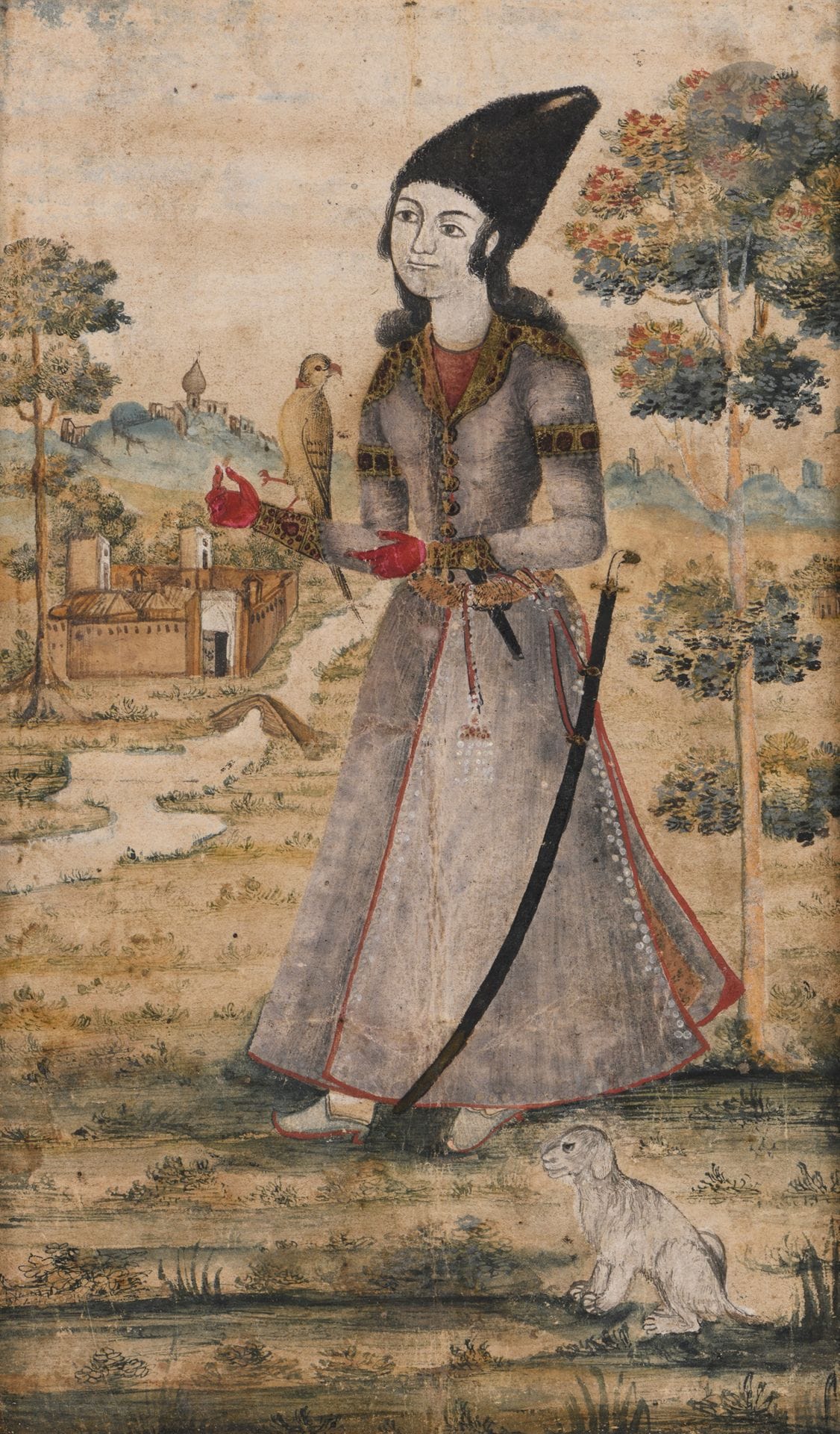 Prince fauconnier, Iran, début XIXe siècle
Gouache, encre et or sur papier cartonné rouge représentant un prince debout dans un paysage de collines traversé par un fleuve et ponctué d’édifices. Il est coiffé du haut chapeau noir kolah namadi, richement vêtu d’un manteau à passementeries dorées à la ceinture duquel est glissé un poignard et est accroché un sabre shamshir. Il porte des gants rouges et sur son avant-bras droit est posé un faucon. Un chien se tient à ses côtés.
Dim. peinture : 17,8 x 10,9 cm ; page : 25,1 x 18,5 cm
Usure, petits repeints.