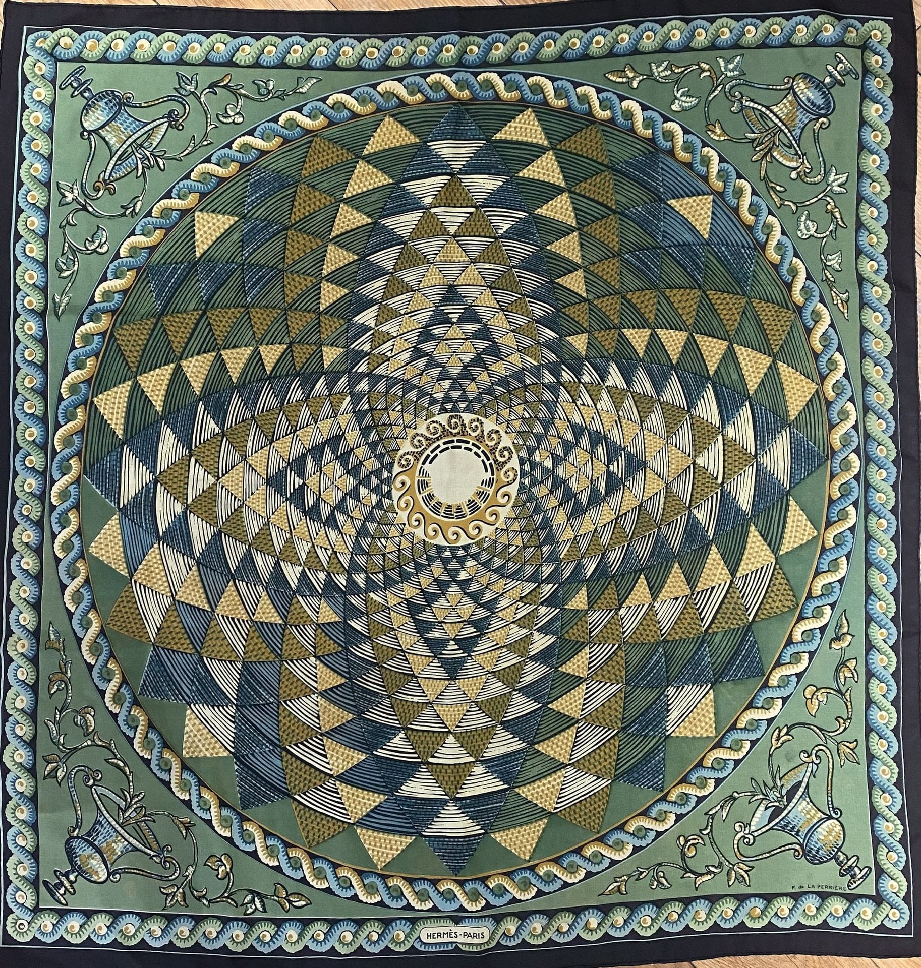 HERMÈS PARIS
Carré 90 in Corinthe silk twill, signed F de La Perrière, green background and black frame (stains and discoloration, small hole).